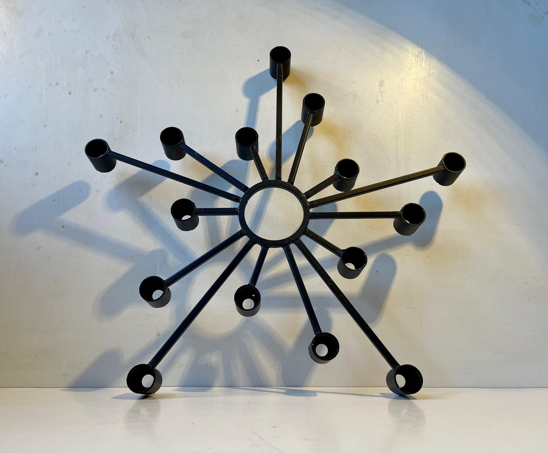 Large 1970s Brutalist - sculptural iron candleholder for up to 15 regular sized candles. Made in Denmark by the metal-art design company Dantoft kunstartikler (trans.: art objects). It is made from black lacquered and welded iron set in a graphic