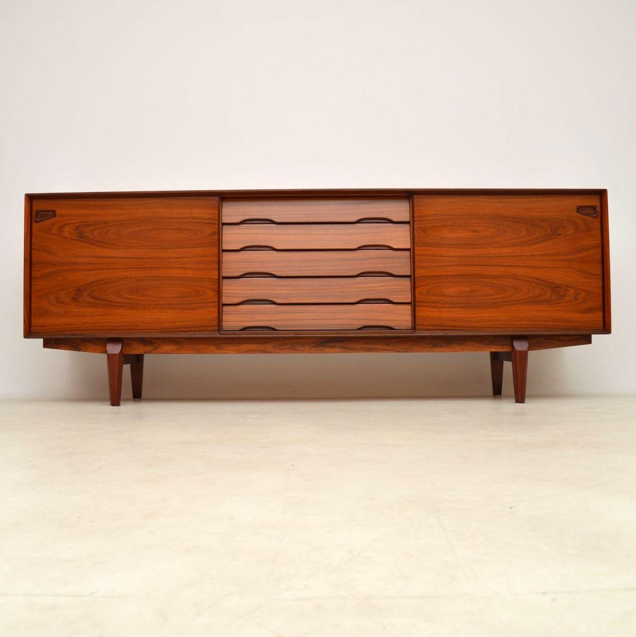 A magnificent vintage Danish sideboard, this dates from the 1960s-1970s and was made by Skovby. It’s of amazing quality, with a stunning wood construction throughout. The grain patterns and colour are simply beautiful, this looks amazing from all