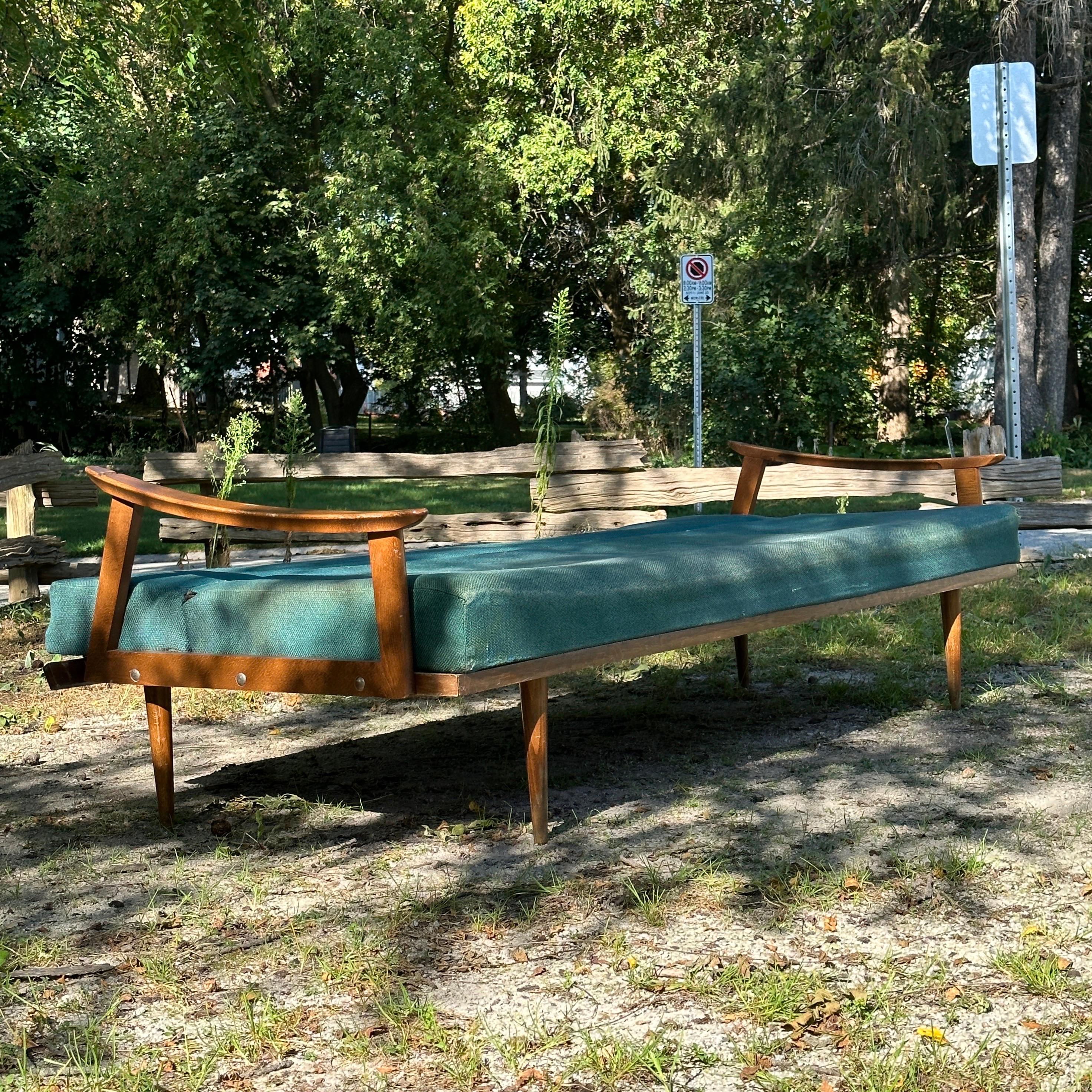 Condition: Fair Vintage Condition

Dimensions: 79” L x 28” D (35” D Bed) x 28” H (15.5” SH)

Description: A vintage elm sofa bed, made in Denmark, circa 1950s. Still usable. Frame is structurally sound. Easily converts to bed with one hand. Can be