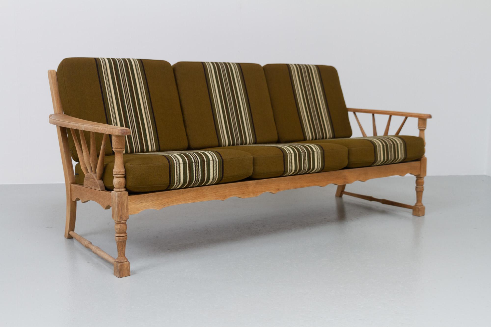 Vintage Danish Sofa in Oak, 1960s.
Danish Mid-Century Modern couch in solid oak with original cushions in wool upholstery.
Made in the 1960s by Danish cabinetmaker. Very likely designed by Henning Kjærnulf, Denmark (born Henry Kjærulff Rasmussen) as