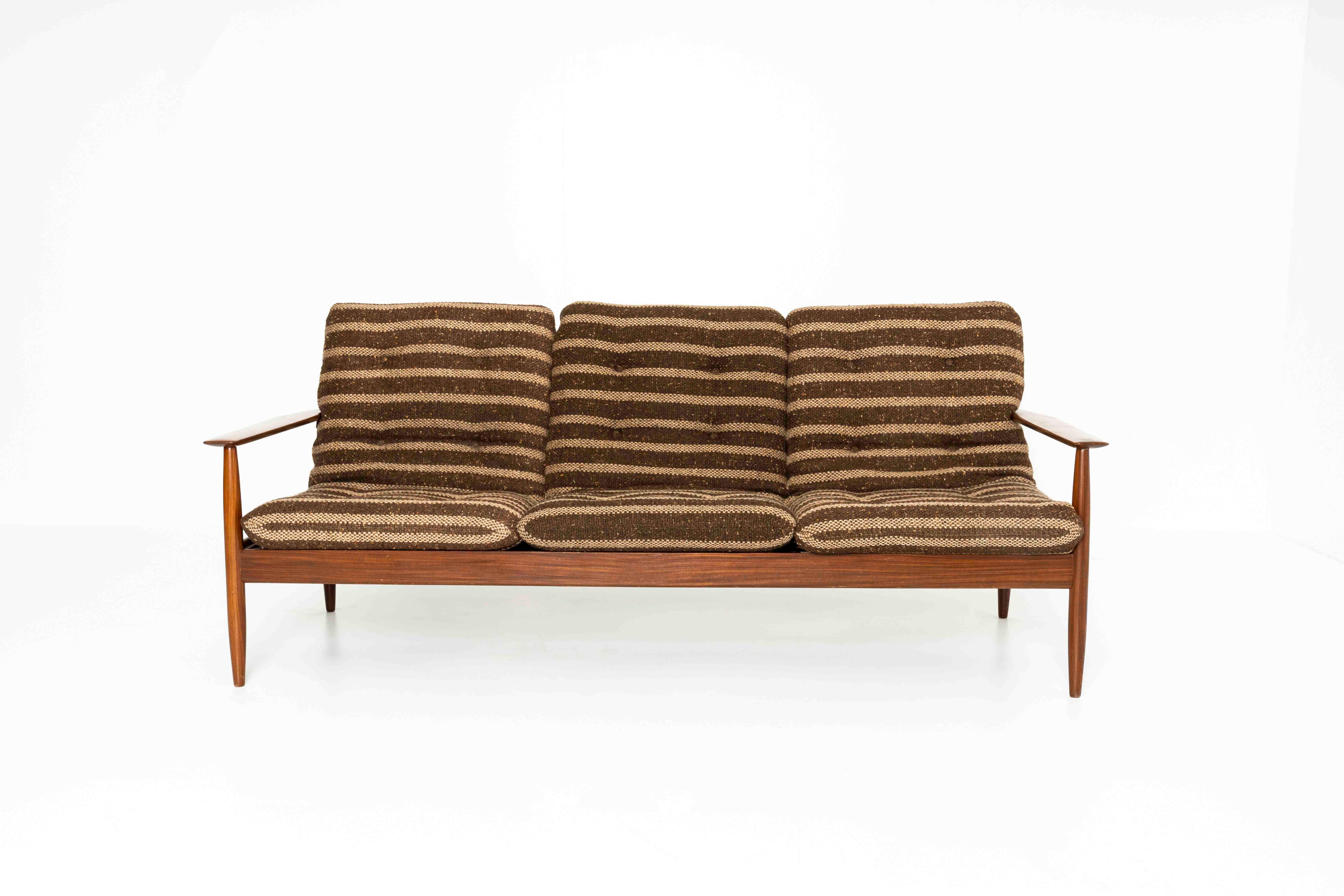 Lovely Vintage Danish Sofa in Teak Wood and Brass from Denmark 1960s. This sofa is very much in the style of Grete Jalk. The set has the original upholstery with three cushions in brown and off-white. The brass knobs are a beautiful detail to this