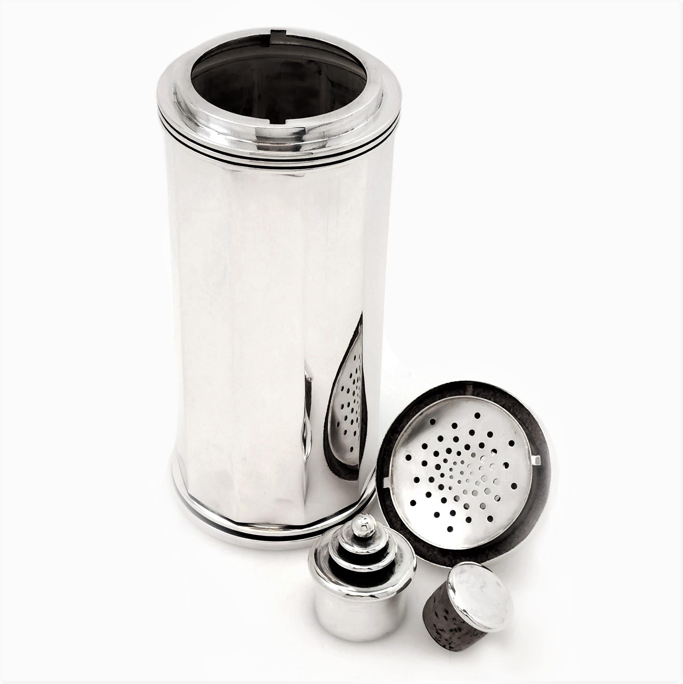 An elegant Danish Silver Cocktail Shaker in a modern Art Deco style decagonal shape. This vintage Cocktail Shaker has a simple, understated design with 10 plain polished side panels. The top of the Shaker has a stepped design and the lid has a round