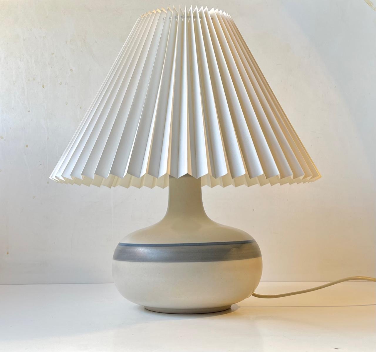 Stoneware Table Light decorated with grey and blue stripes on a pastel main-glaze. Made at Axella Design in Denmark during the 1970s. It was probably designed by either Jette Hellerøe or Tue Poulsen who worked at the studio during this time.