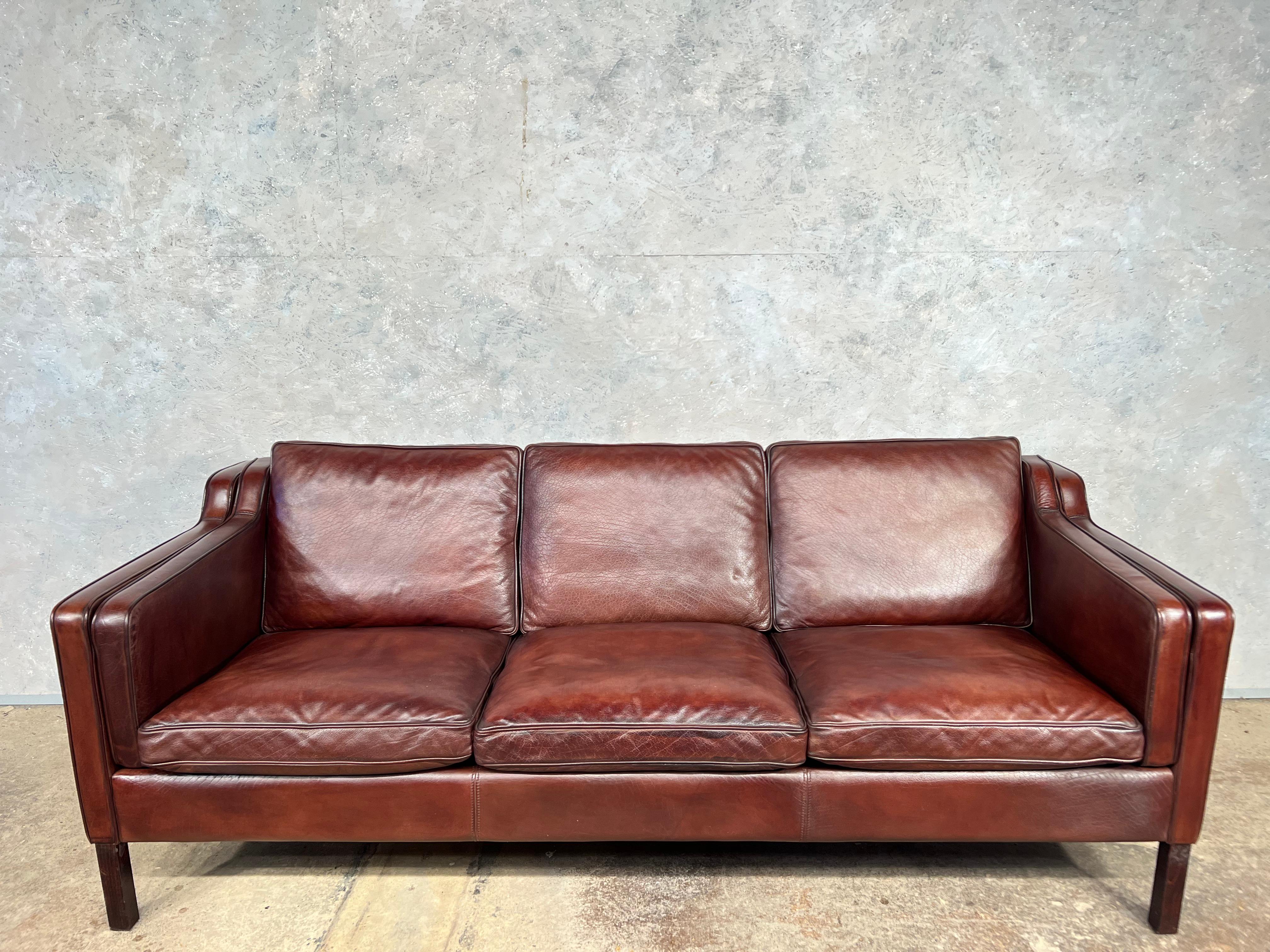 Vintage Danish 70s mid-century chestnut three seater leather sofa by Stouby.

In the Borge Mogensen style, fantastic quality with feather filled cushions, very stylish design with curved arms and back, in great condition, restored and hand dyed a