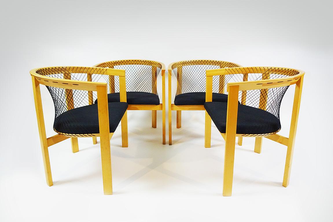A set of 4 unusual string backed vintage dining chairs in Beech wood by Niels Jørgen Haugesen.

Niels Jørgen Haugesen was born in Denmark in 1936. And worked with many notable Danish designers including Arne Jacobsen. He set up his own design