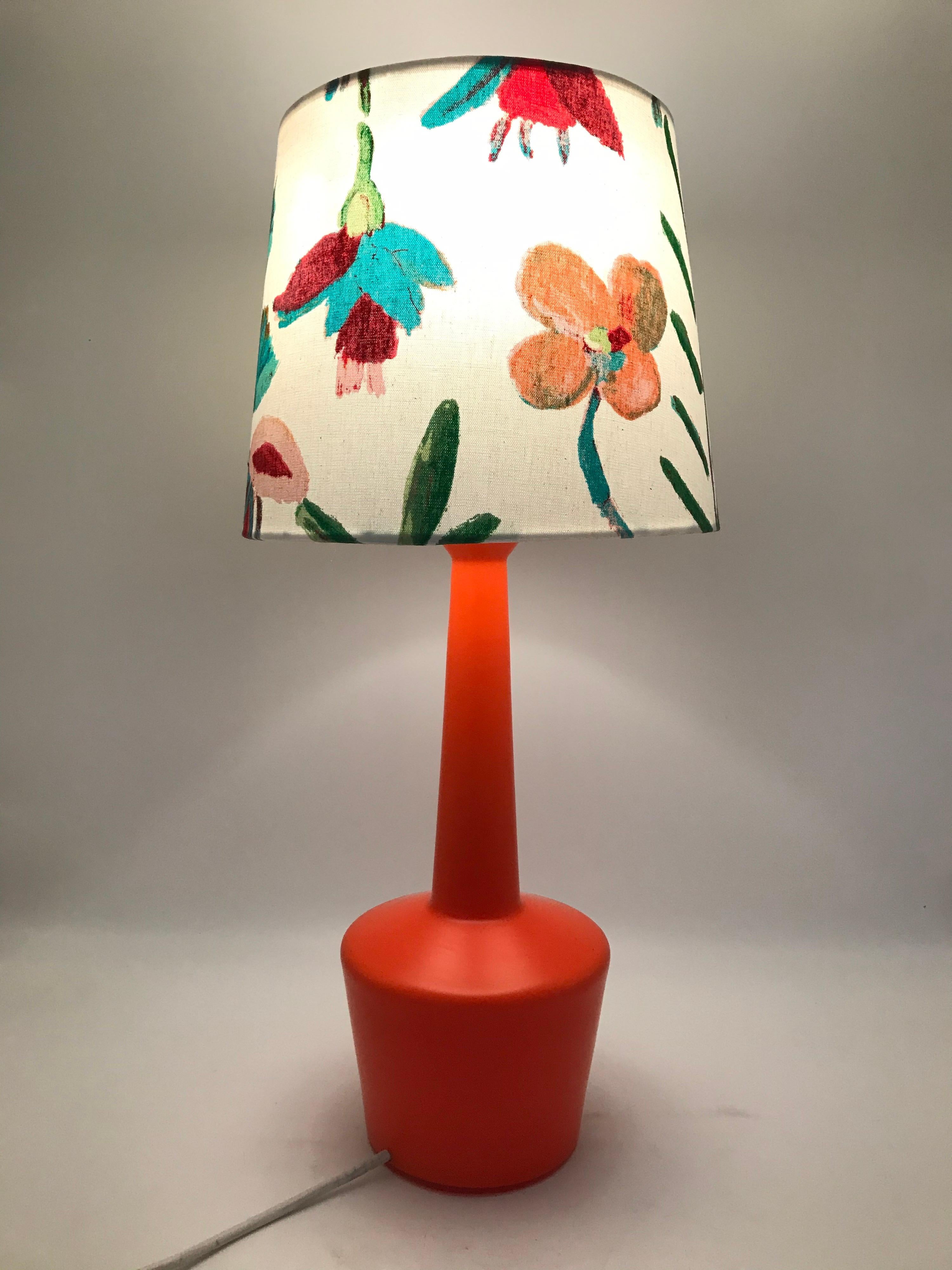Vintage Danish table lamp by Kastrup Glass Works from the 1960s and with a limited edition handmade shade by Artbymaj.
Each shade is unique and handmade.
The glass lamp with its stunning orange color together with the floral design on the white