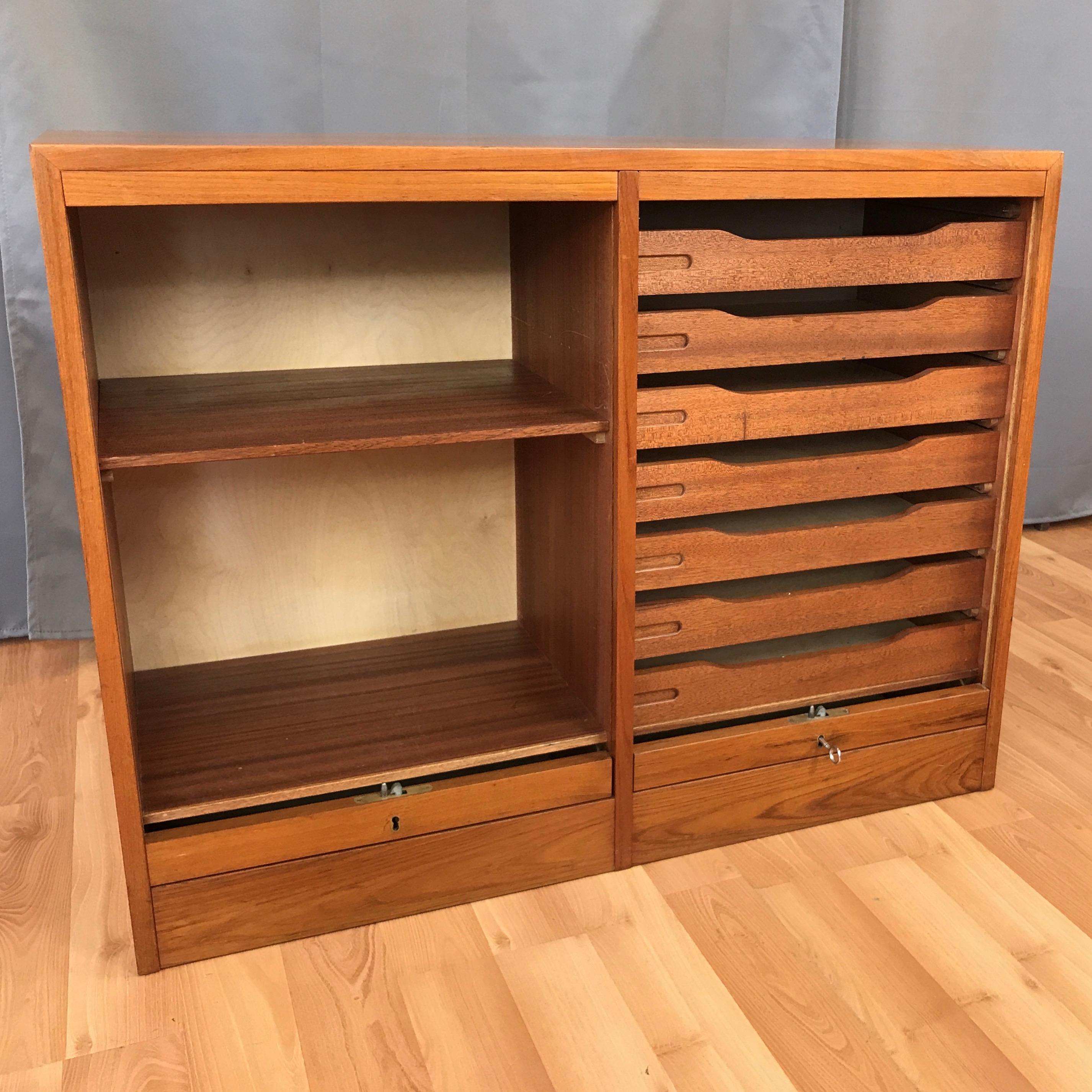 A vintage Danish dual compartment teak file cabinet with locking tambour doors.

Very clean design features smooth front tambour doors that roll down into the base and out of sight. A cabinet with removable shelf is on the left, while a cabinet with