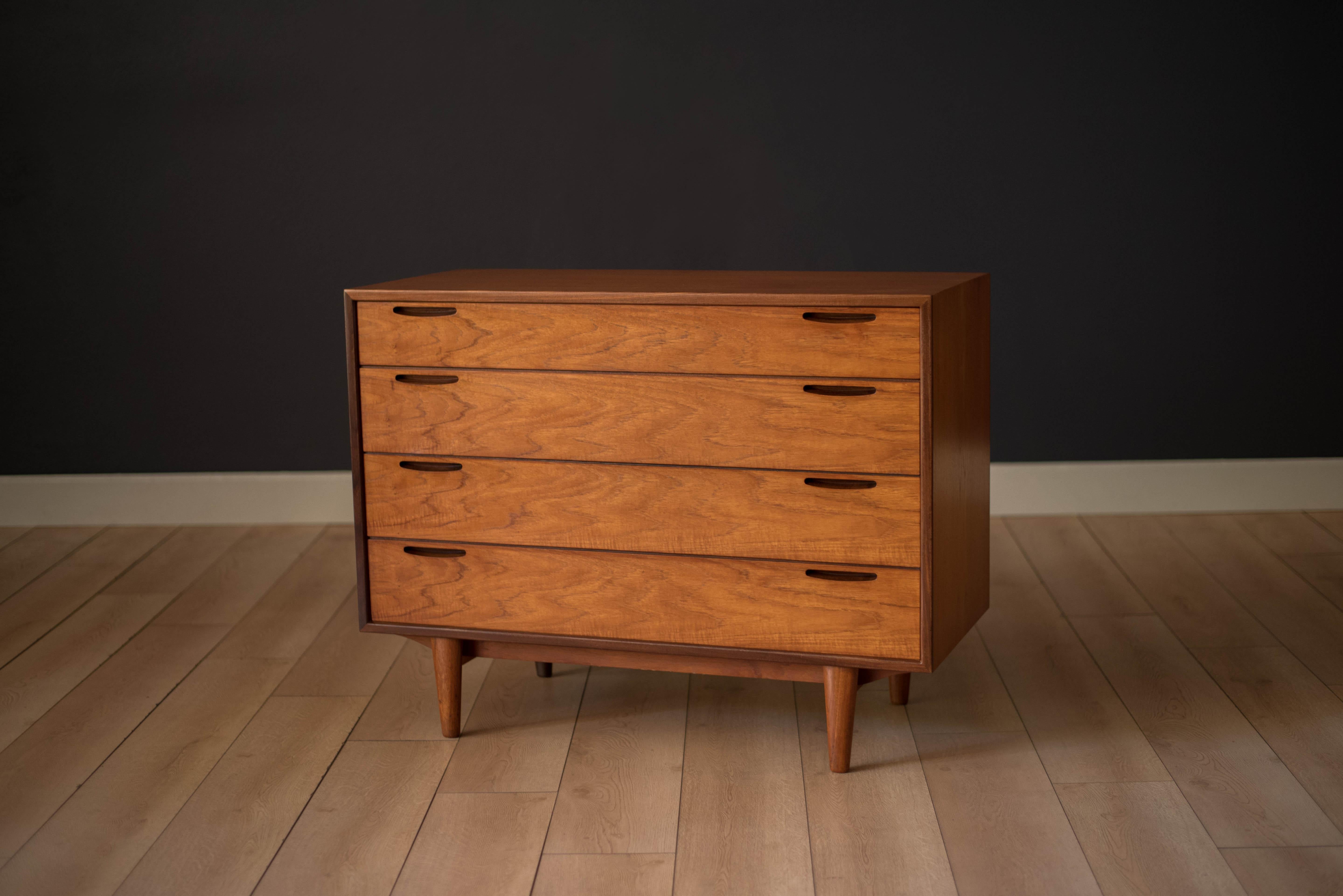 Mid-Century Modern dresser chest designed by Ib Kofod Larsen for J. Clausen Brande Møbelfabrik. This piece features sculpted inset handles and contrasting solid teak edge banding. Includes four drawers lined with teak interior. Backside is finished