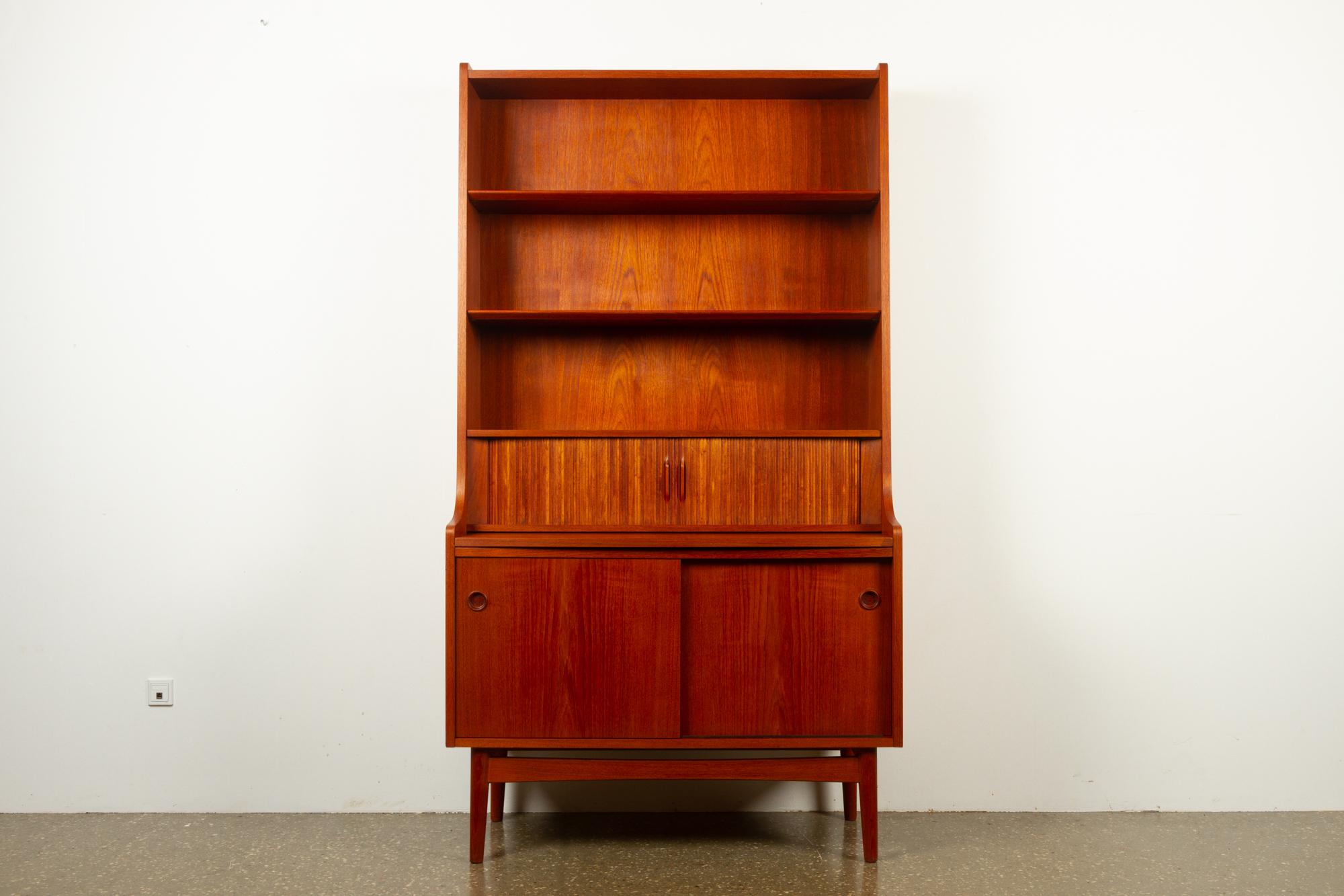Vintage Danish teak bookcase by Johannes Sorth for Nexø Møbelfabrik, Bornholm, Denmark. Date of production Dec 9th 1964.
Very versatile tall book case with shelves, cabinet and drawers, also functions as a secretaire as the large shelf under the