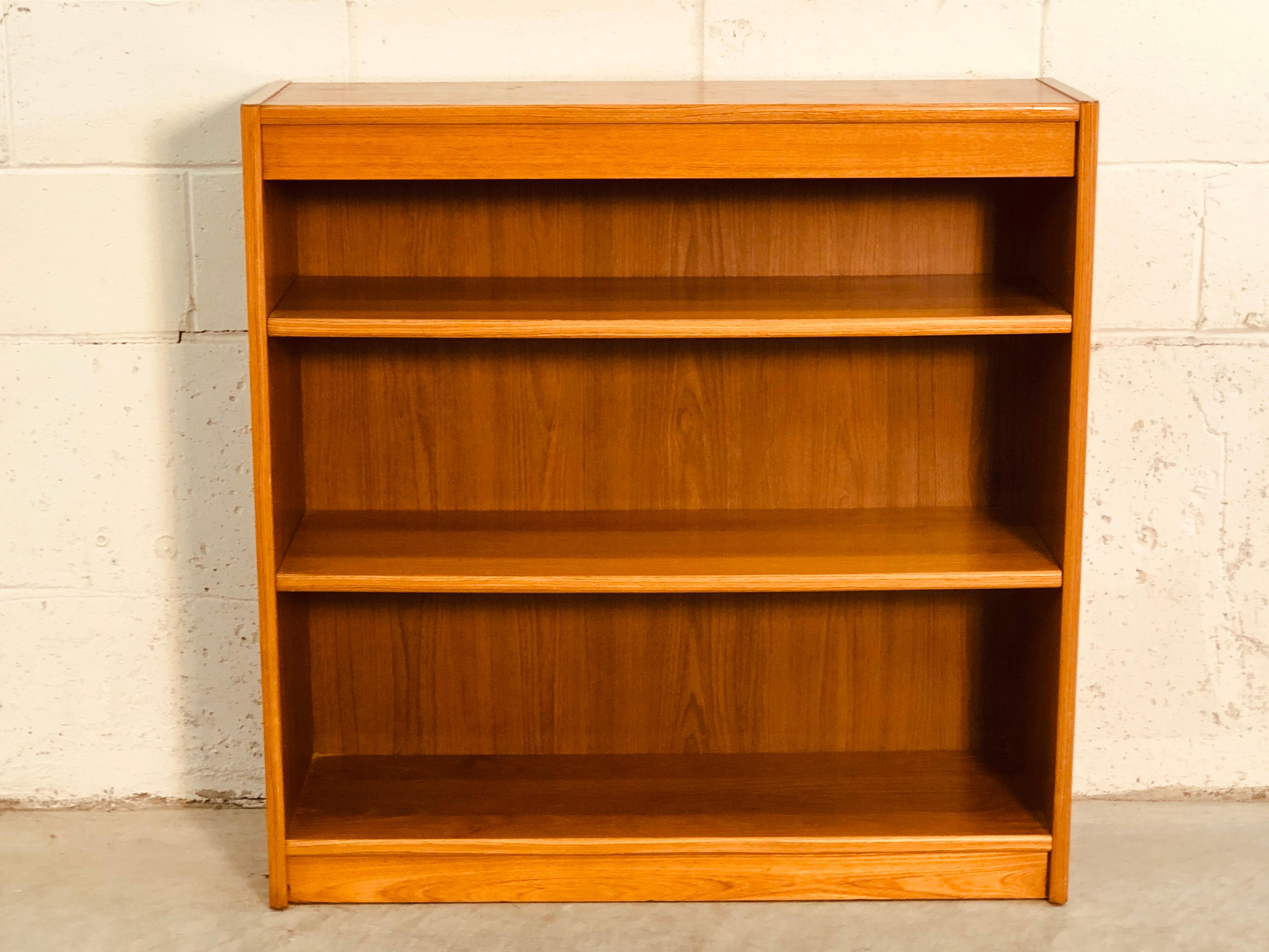 Vintage 1970s Danish teak bookcase with adjustable shelving. Great for storage and shelving can accomodate different options. Marked underneath.
