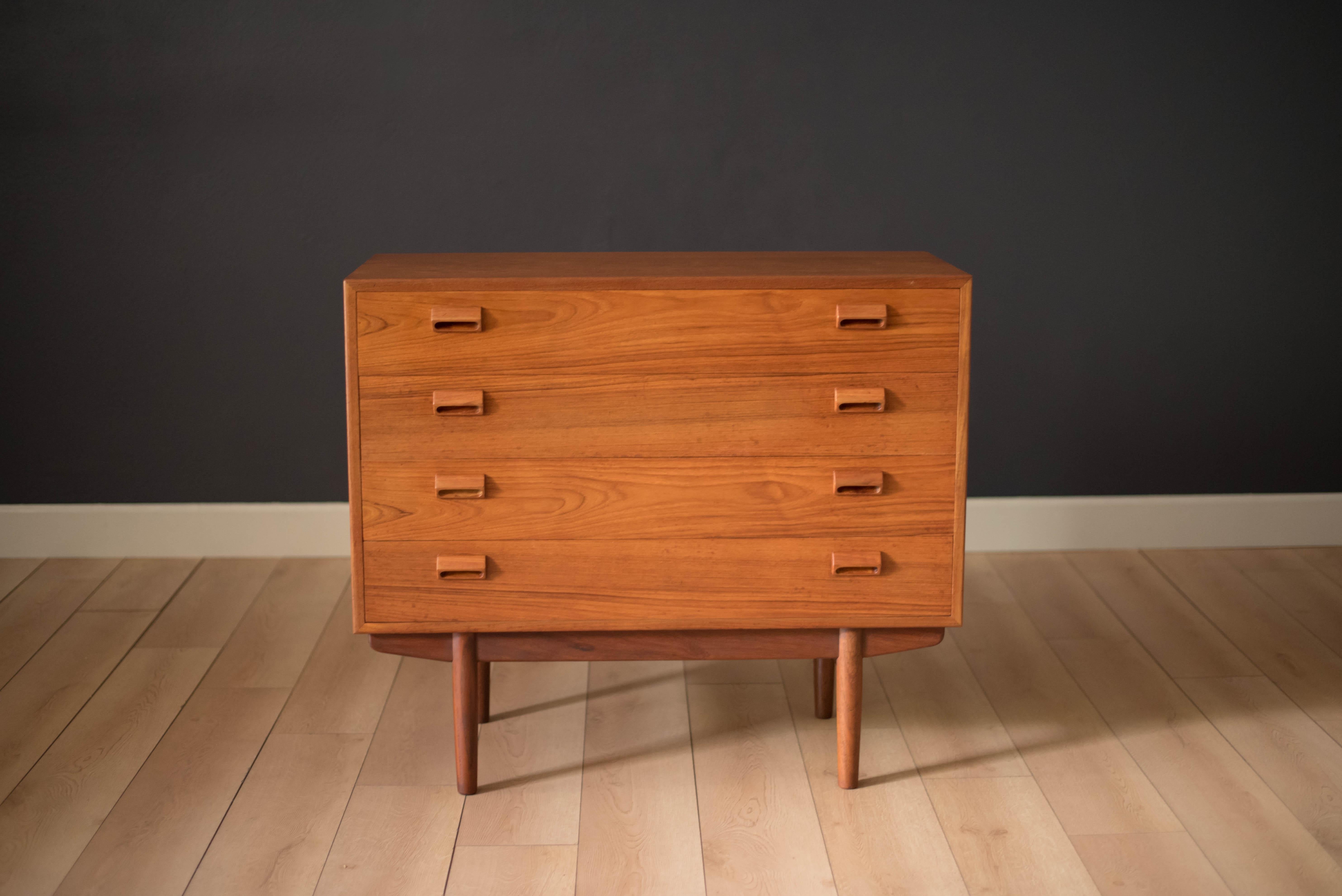 Mid-Century Modern dresser chest by Børge Mogensen for Søborg Møbelfabrik. This piece displays a flowing teak grain pattern and includes four dovetailed drawers accented with the designer's signature sculpted handles. Base is also finished in