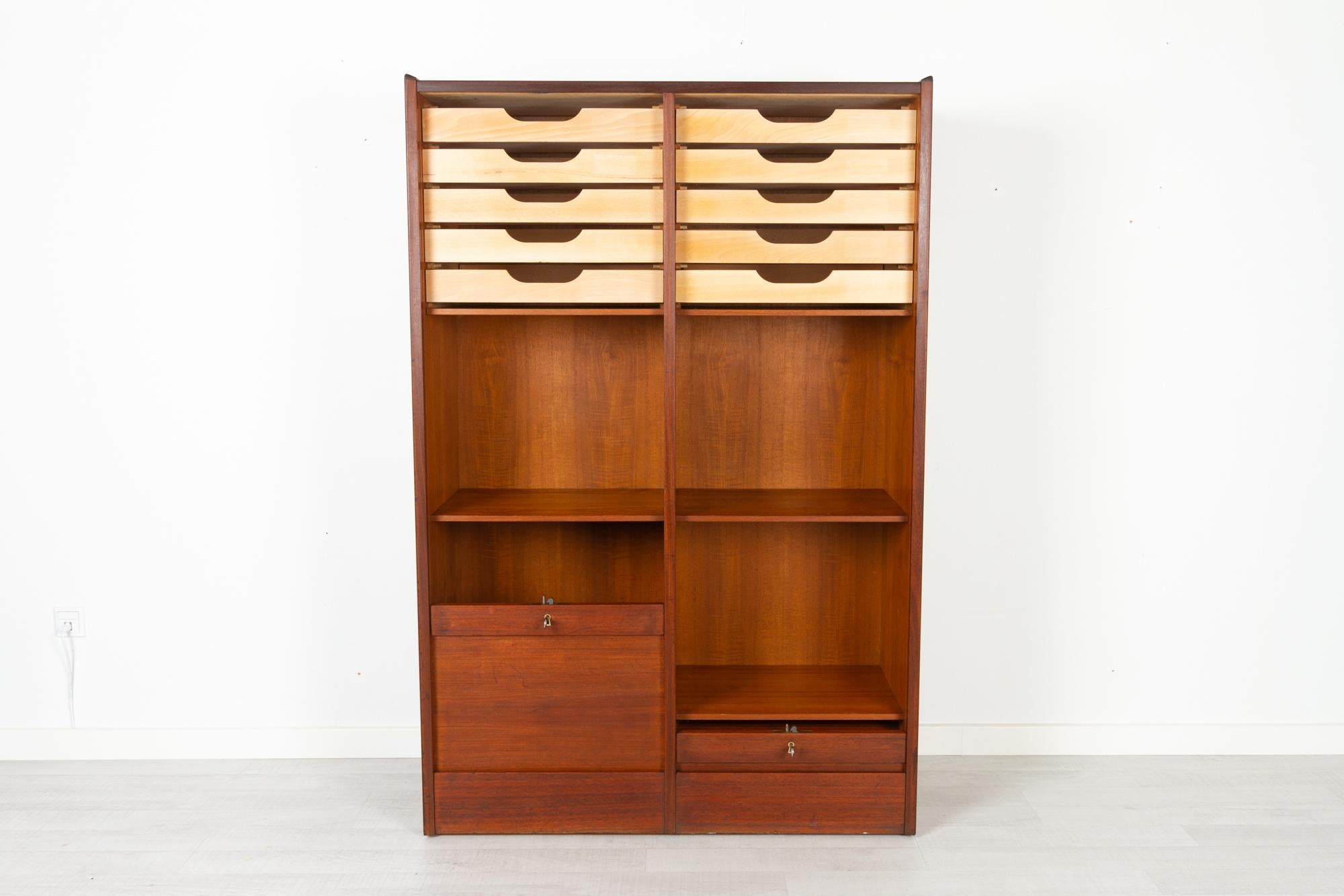 Vintage Danish teak cabinet with tambour doors 1960s
Large Danish modern cabinet with double vertical tambour doors with slats in solid teak. Two compartments, each with two fixed shelves and five drawers. Drawers in solid beech and dovetail