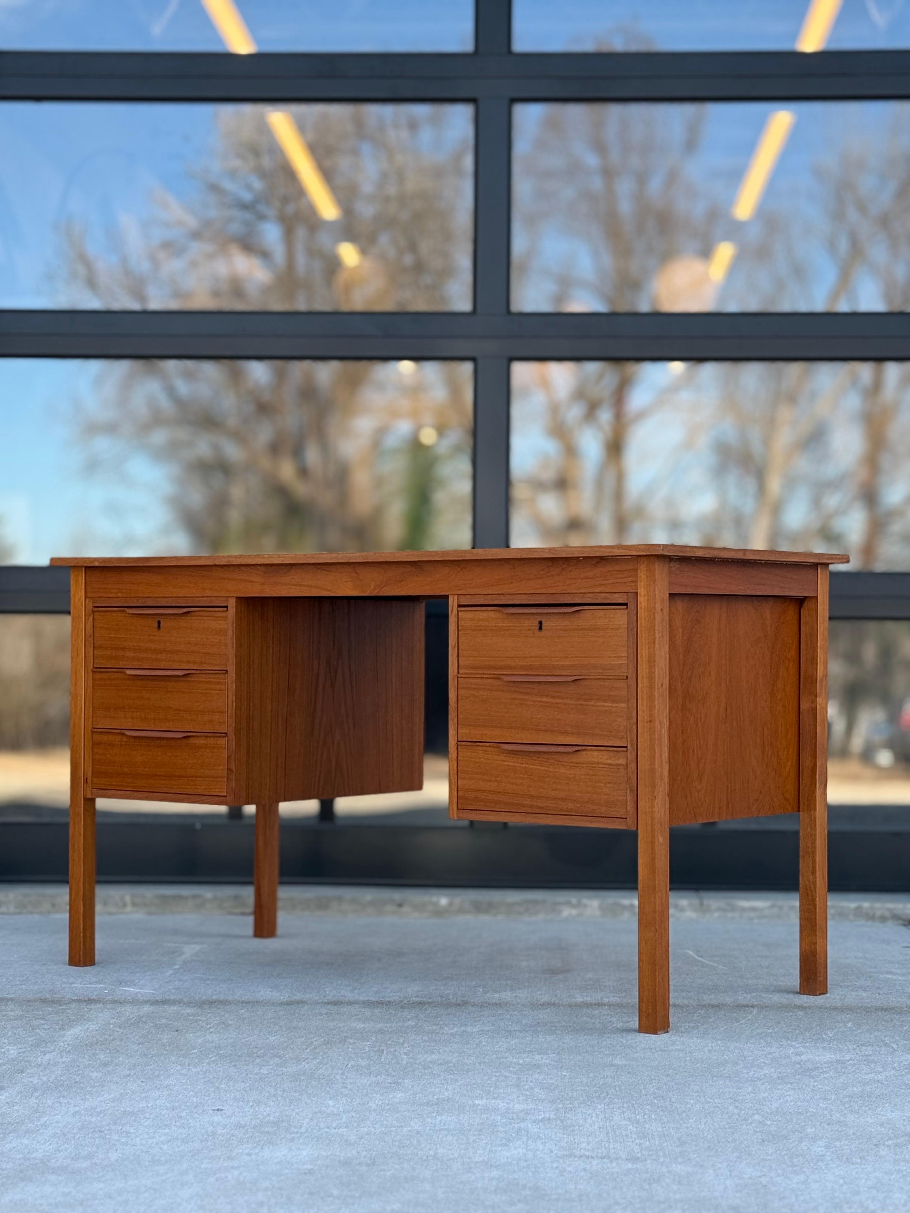 Vintage danish teak desk by Bent Silberg Mobler.  A perfect addition for any home office or room with a medium size foot print.  Nice teak sculpted drawer handles and double locking top drawers with single key.  The finished back allows options to