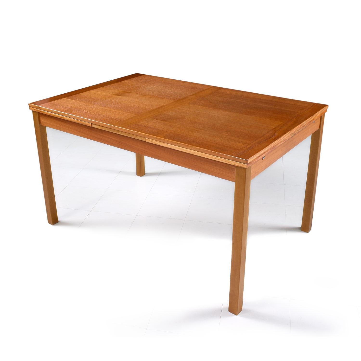 Made by Ansager Mobler, circa 1970s. The contrasting butcher block style wood grain on the leafs enhance the simple and Minimalist nature of this this Scandinavian design. Teak top with light colored beechwood legs. In the Classic style of Niels