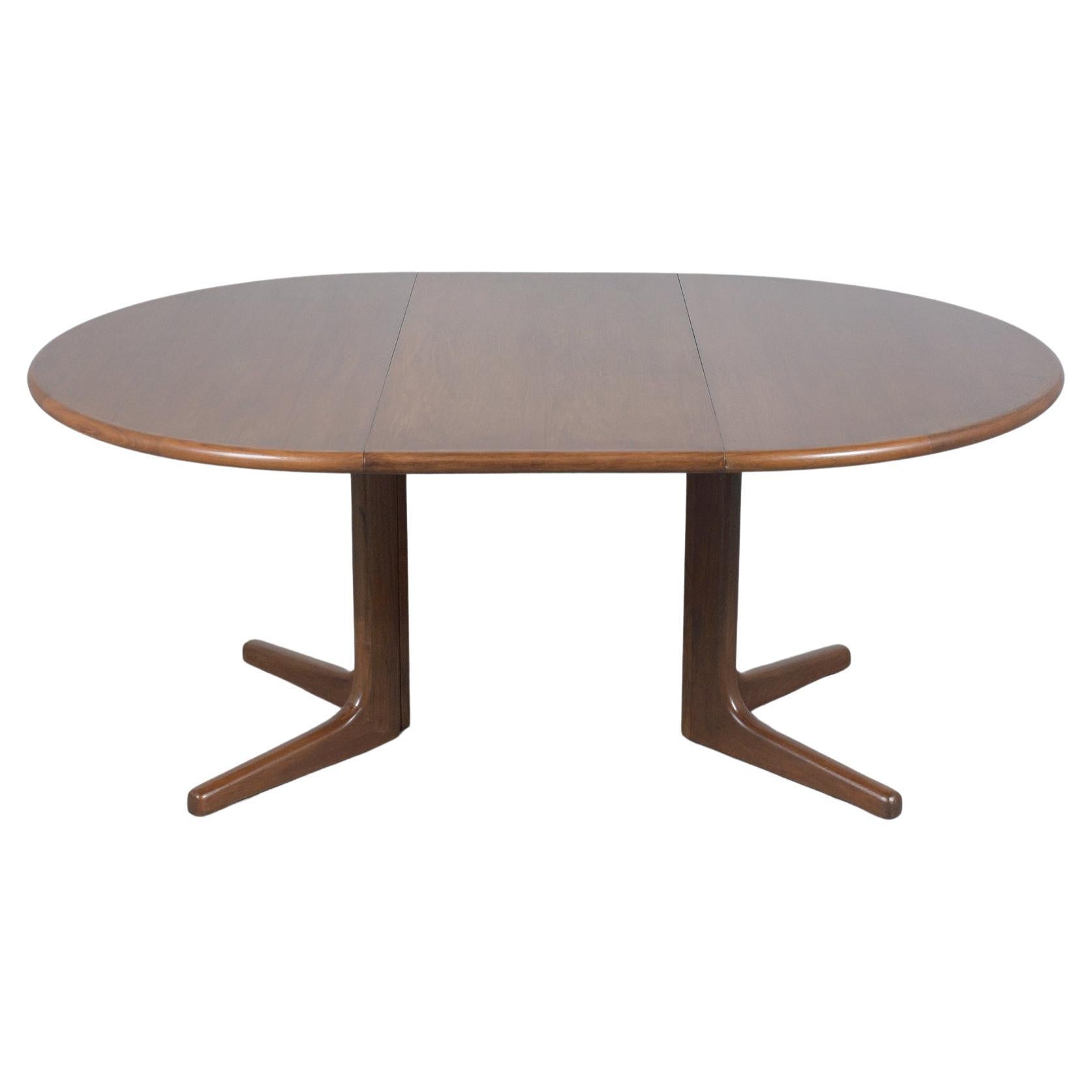 Discover the allure of Danish design with our exceptional vintage extendable dining table, embodying mid-century modern elegance. This table has been expertly crafted from teak wood and meticulously restored by our skilled in-house craftsmen to