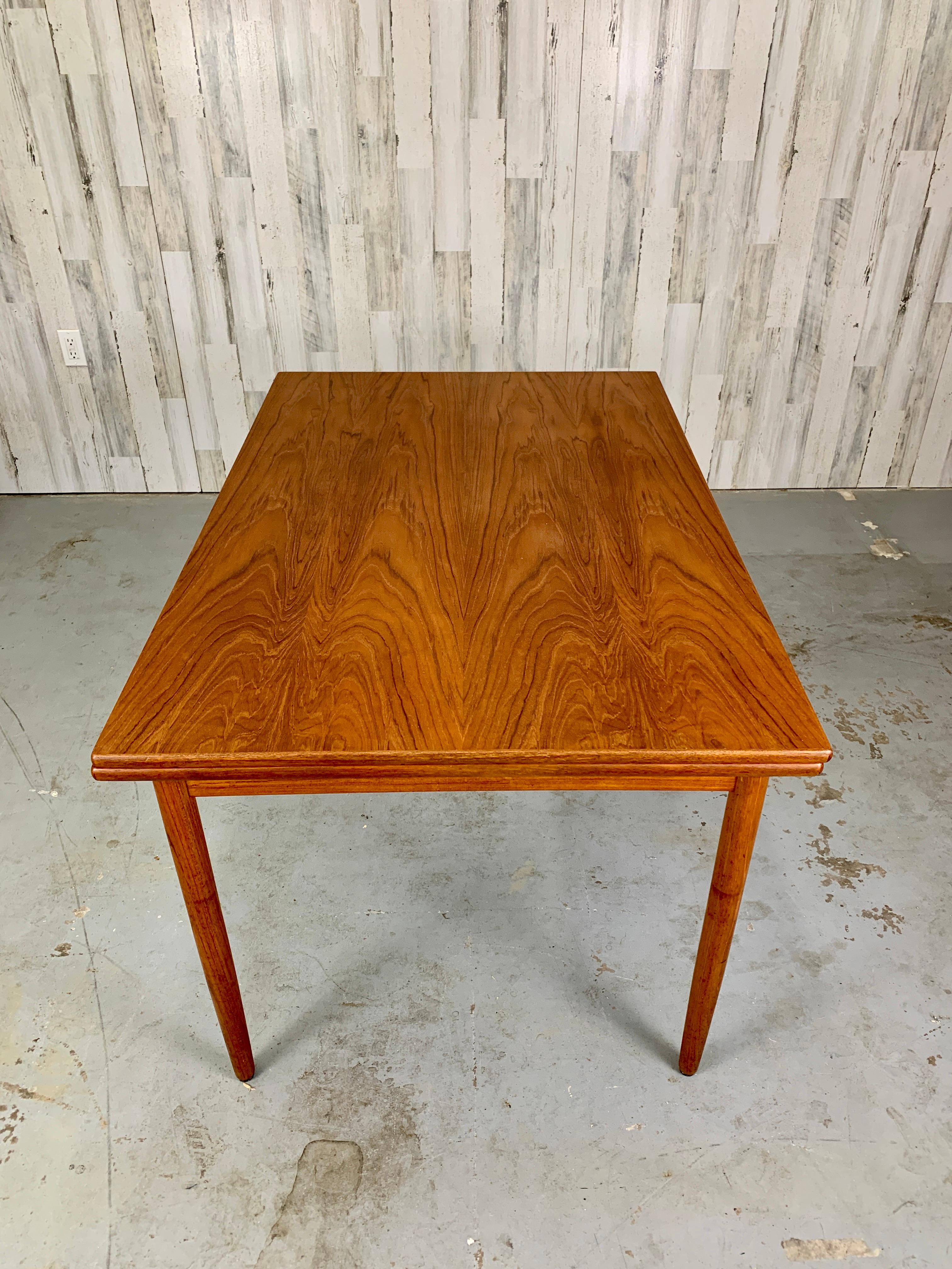 Danish teak dining table with draw leaf. Make in Denmark stamp on bottom. Chairs sold separately. 
Each leaf is 17.75 
Total length with both leafs is 86.75.
 