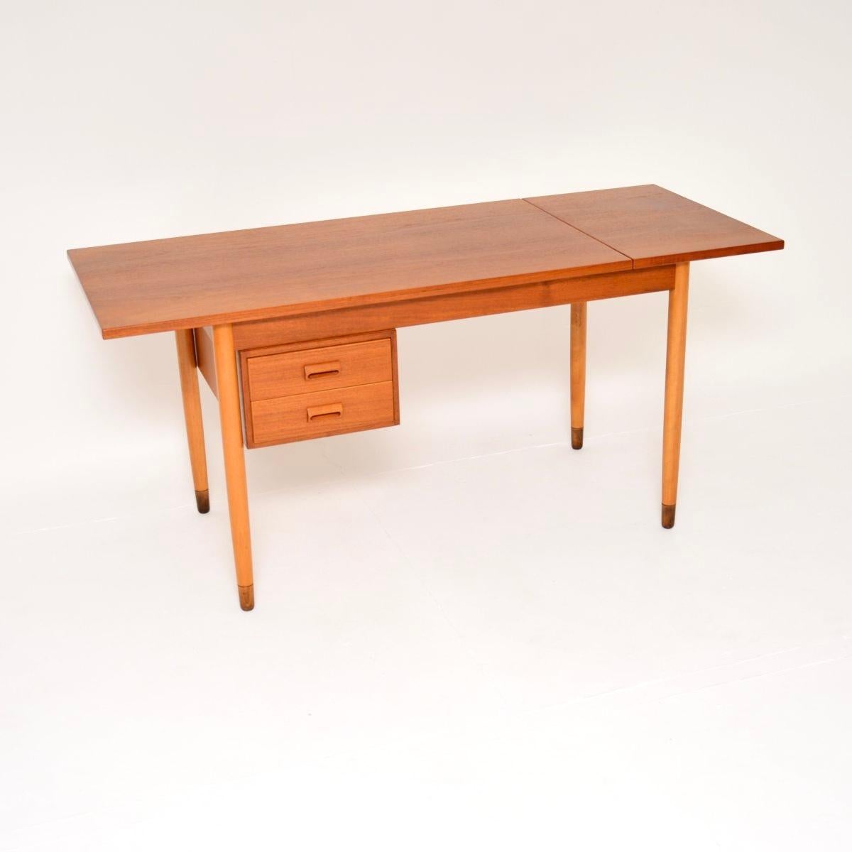 A stylish and extremely well made vintage Danish teak drop leaf desk by Borge Mogensen, dating from the 1960’s.

This is of amazing quality and has a wonderful design. It is a lovely fairly compact size, with a drop down leaf that lifts up and