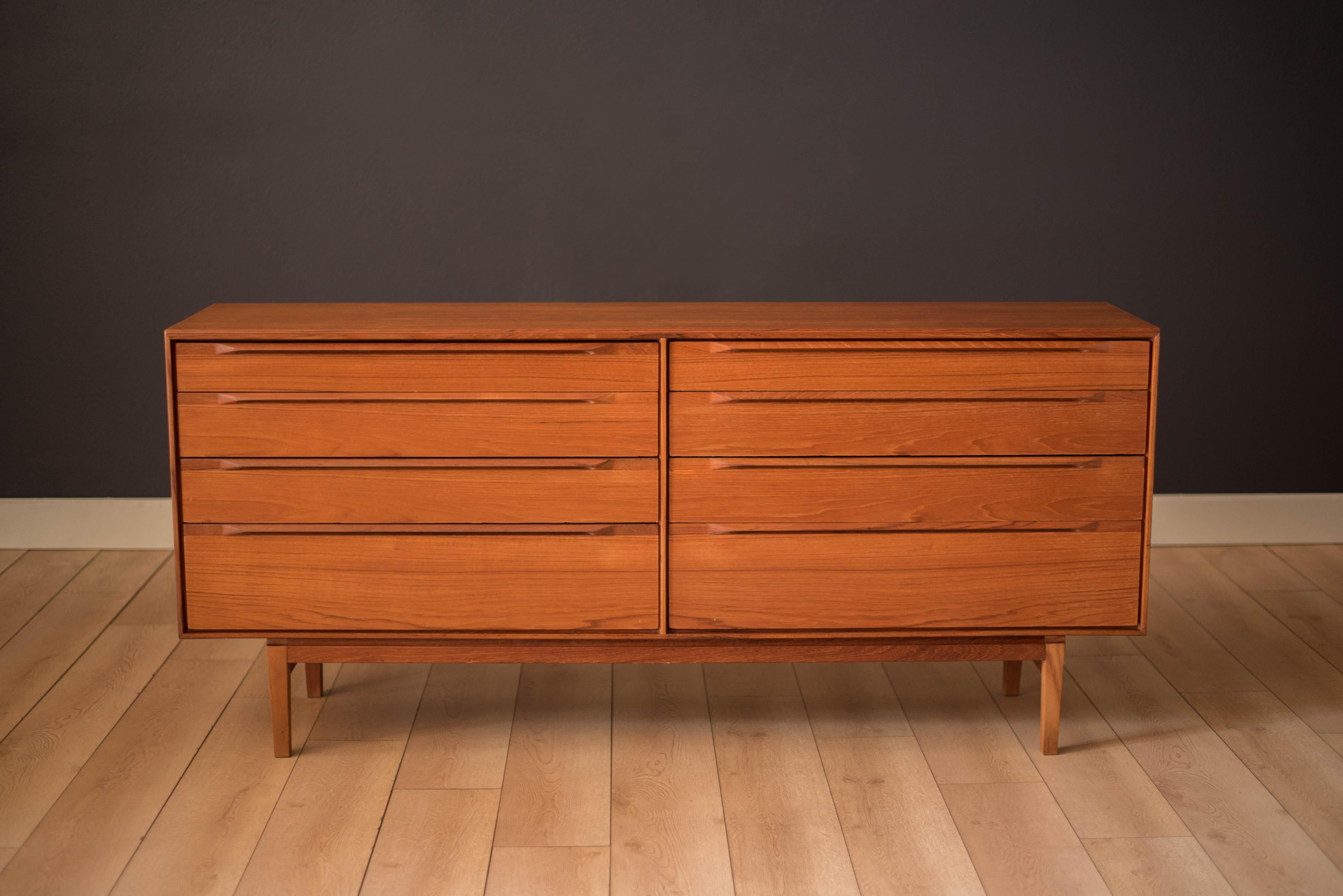 Mid-Century Modern dresser designed by Ib Kofod-Larsen for Fredericia Møbelfabrik in teak. This piece offers plenty of storage including eight dovetailed drawers with contrasting sculpted handles and detailed construction. Additional organizing