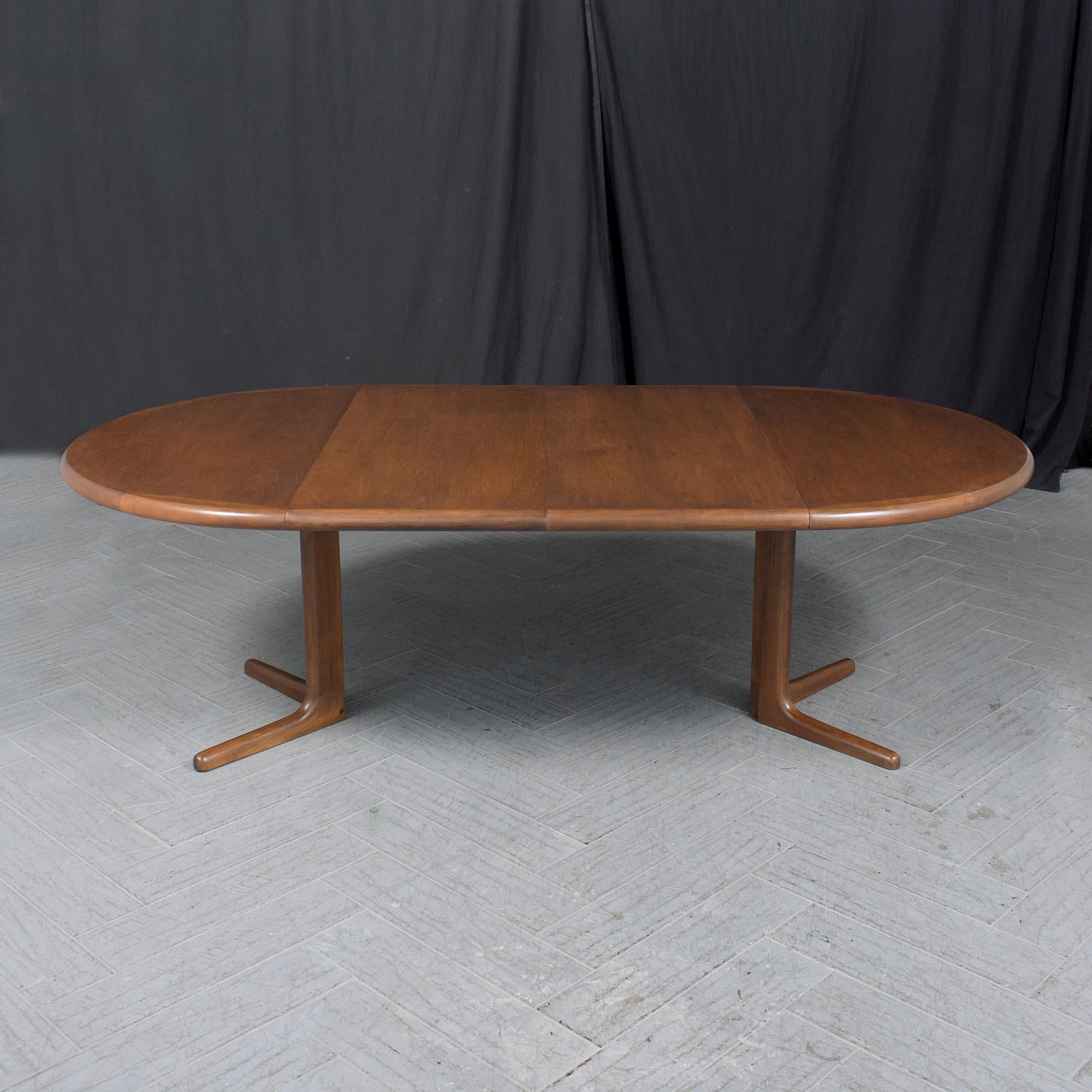 Enter the realm of classic Danish design with our exquisite vintage extendable dining table, a testament to the mid-century modern ethos. Expertly restored by our skilled in-house craftsmen, this teak table exudes style and quality. It boasts a