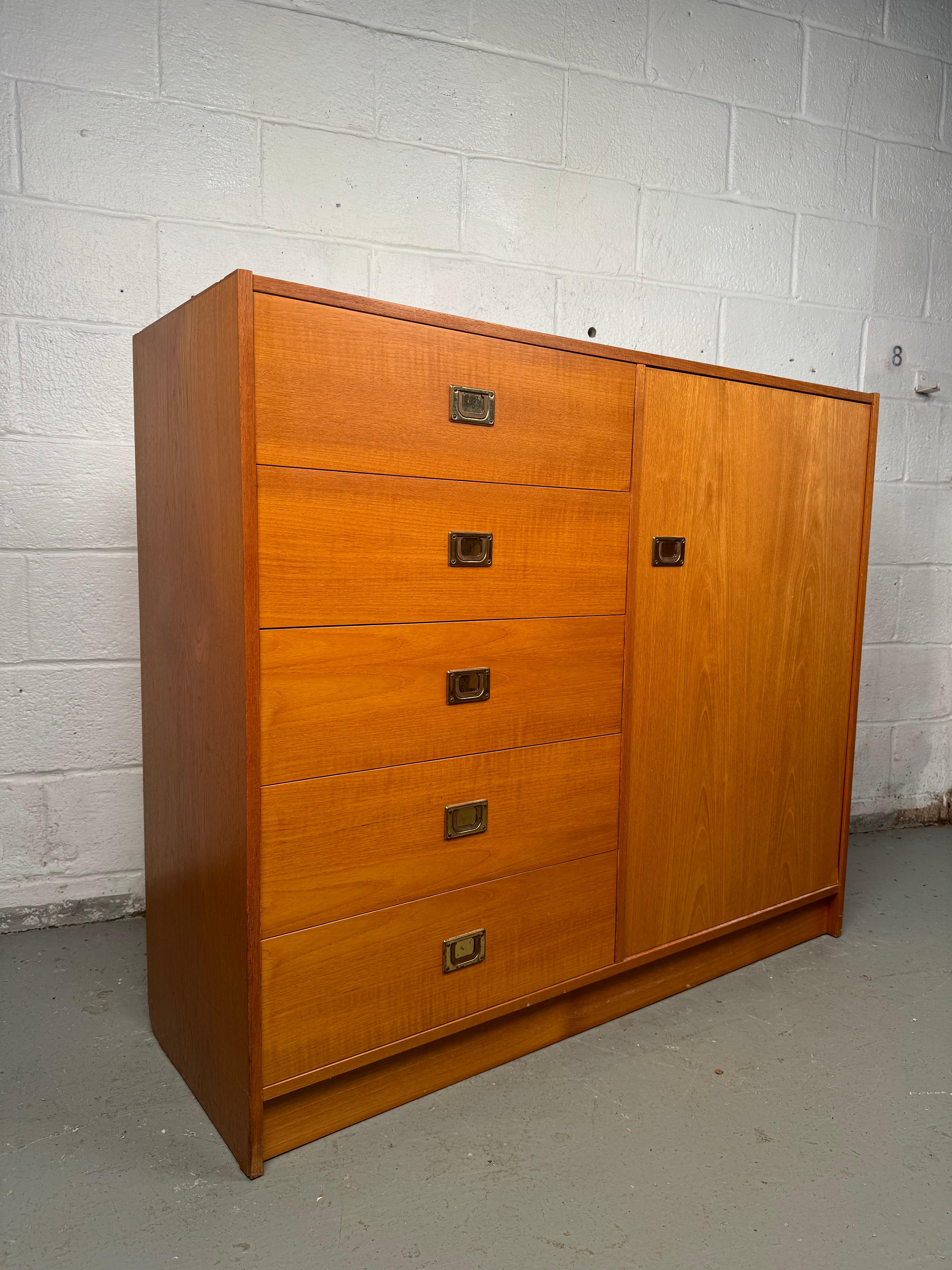 Vintage Danish Teak Gentlemans Chest Dresser. Crafted from rich, warm teak wood, this dresser offers both refined style and practical storage. Its sleek lines, minimalist form, and expertly constructed drawers capture the essence of Danish