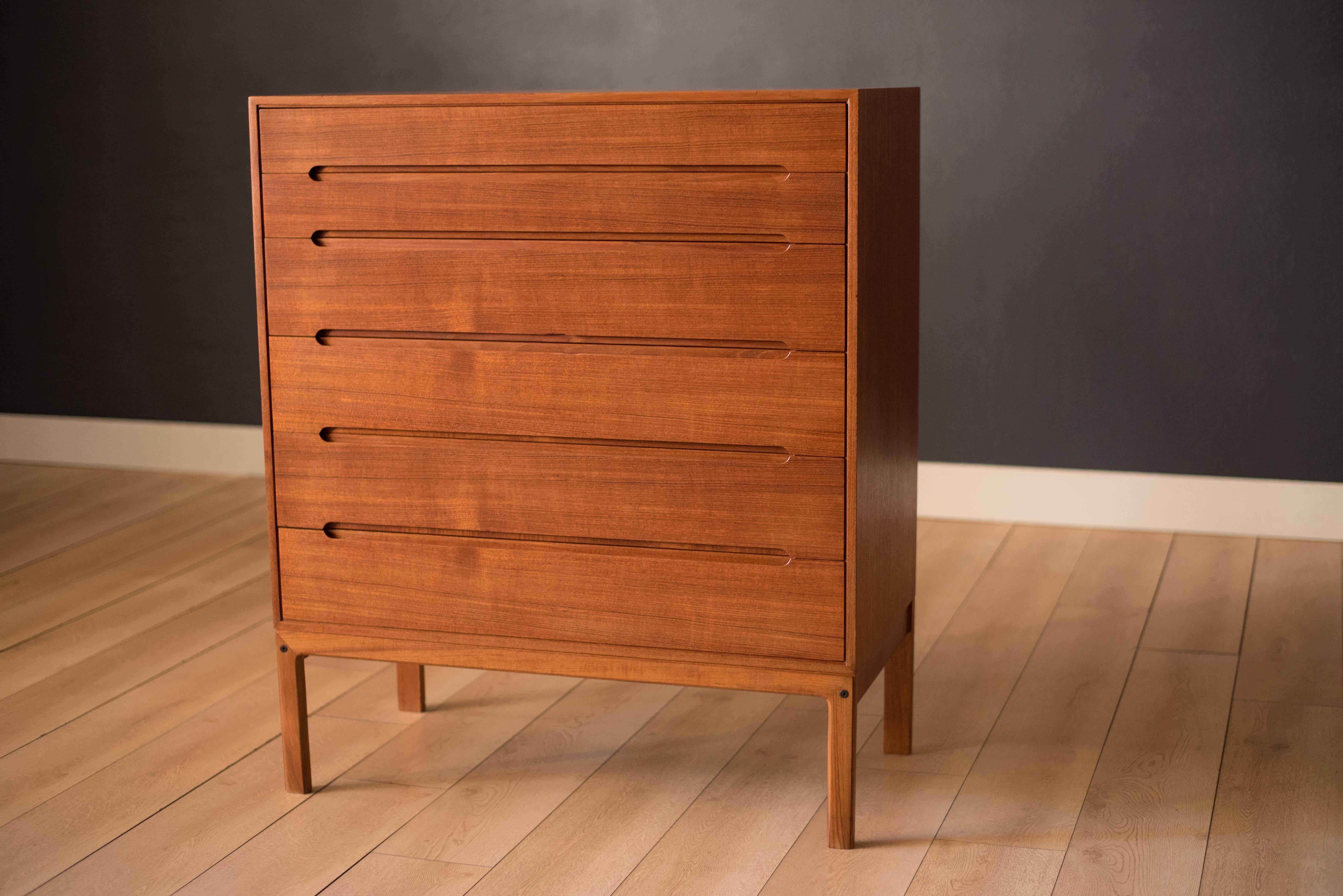 Mid-Century Modern highboy dresser chest in teak designed by Arne Wahl Iversen for Vinde Møbelfabrik. This piece offers plenty of storage including six dovetailed drawers with inset sculpted handles. All interior drawers are lined in