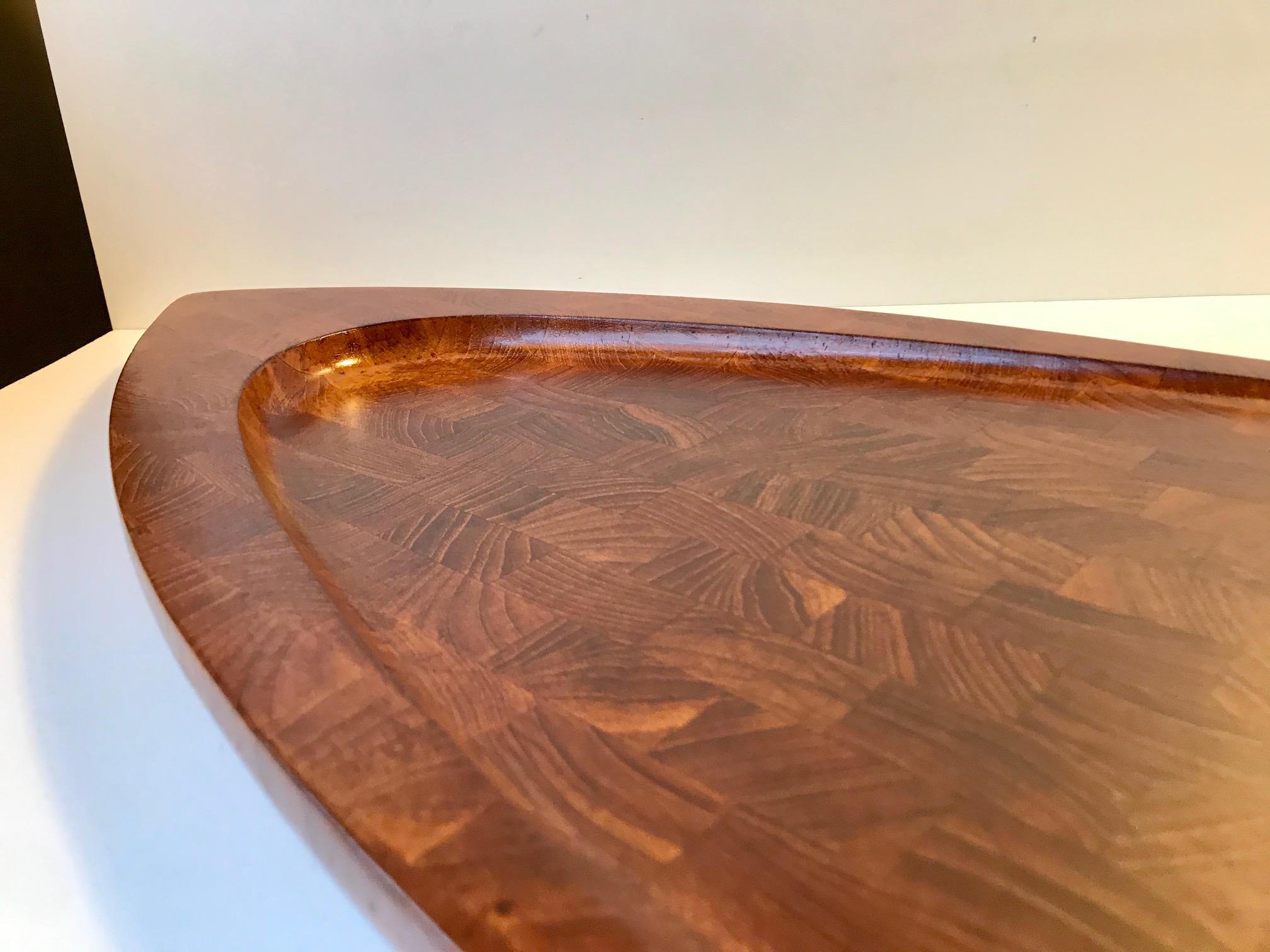 Large wall hung meat serving or cutting board in solid stacked teak. Designed by Flemming Digsmed and manufactured by his Company Digsmed during the mid to late 1960s. This cutting board has been cleaned, sanded and oiled and its condition is