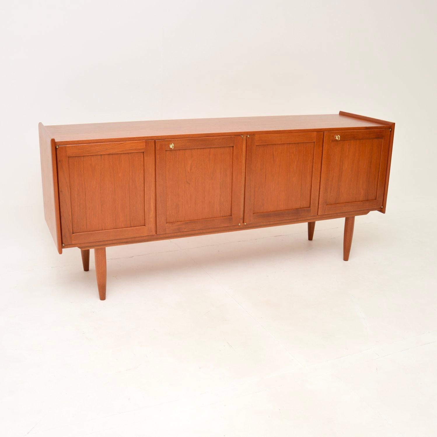 A stylish and extremely well made vintage Danish teak sideboard. This was made in Denmark, it dates from around the 1960’s.

The quality is outstanding, this is beautifully designed and is a very useful size. It sits on nicely tapered legs, the
