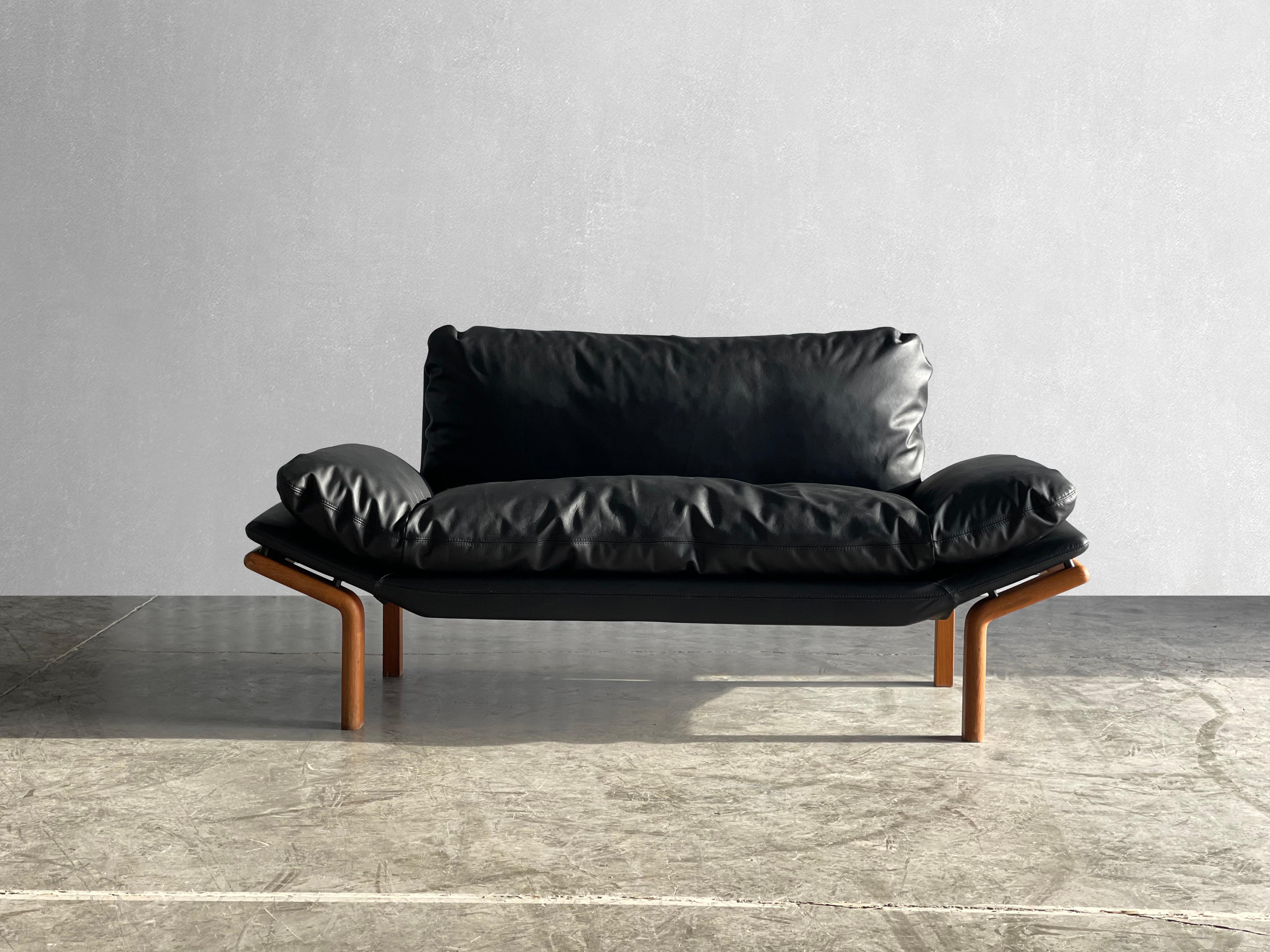 circa 1970s

Original solid teak wood frame. The cushions look as if they are floating. Love the minimal and timeless design. Reupholstered in soft black leather.

Very comfortable for sitting and lounging, and ideal size!

Dimensions:

66L