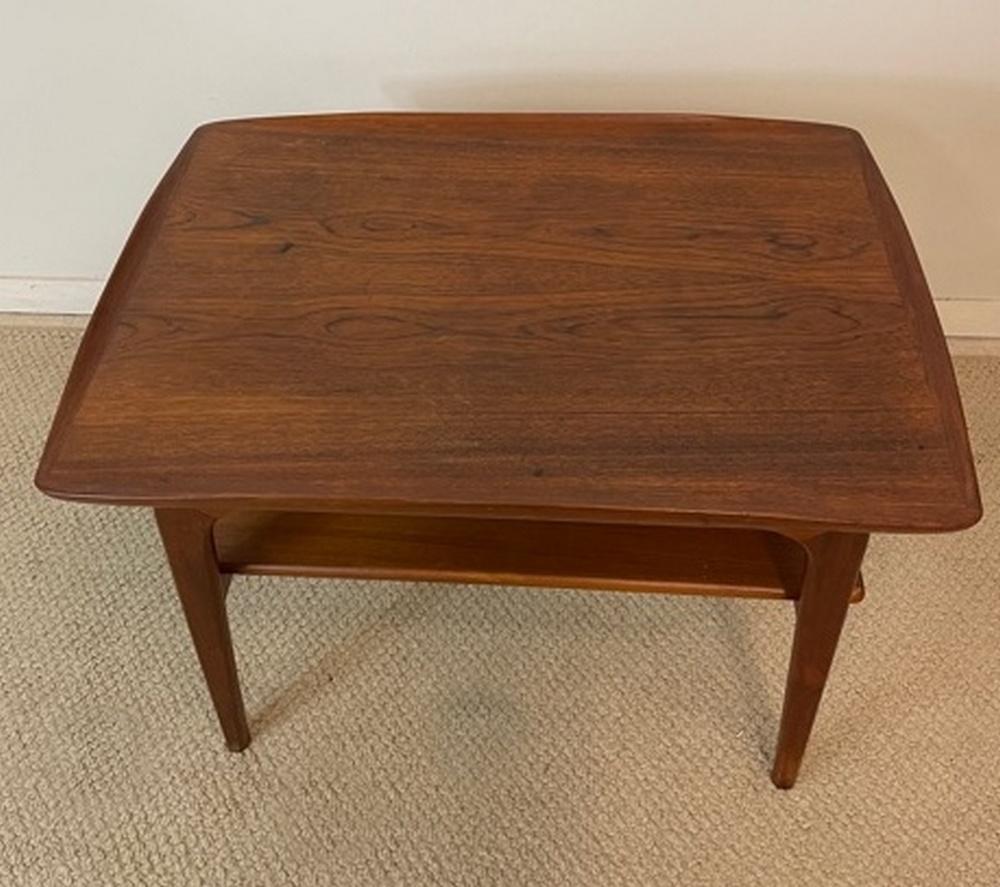 Vintage Danish teak table Arne Hovmandt - Olsen Mobelfabrikken Tobten. Denmark Randers on the label. Lipped sides and turned up ends with a floating top. Very nice condition. Dimensions: 18.75