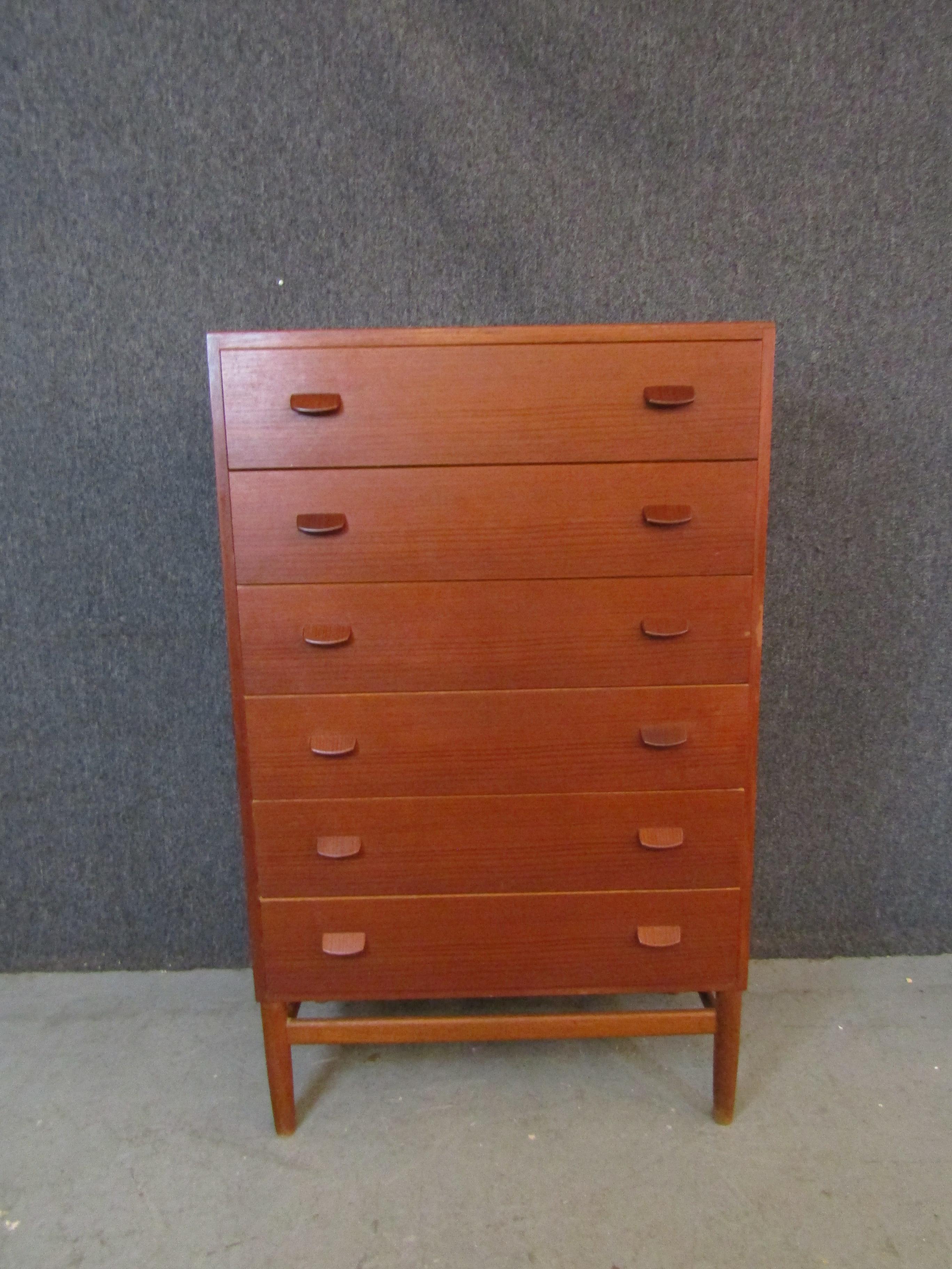 Bring home the timeless Scandinavian minimalism that exemplifies classic mid-century modern aesthetic with this stunning tall teak dresser designed by Denmark's Poul Volther. Six spacious pull-out drawers feature solid wood construction with fine