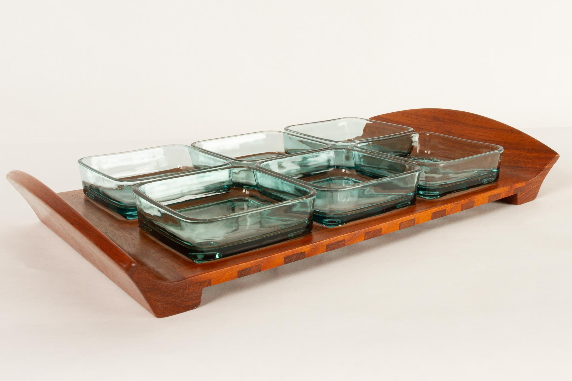 Vintage Danish teak tray with glass bowls by Jens Harald Quistgaard for IHQ Dansk Designs, 1960s.
Serving tray in solid teak with six green glass dishes. Each dish has feet that fits into the lattice on the tray. Length 46 cm. Marked JHQ