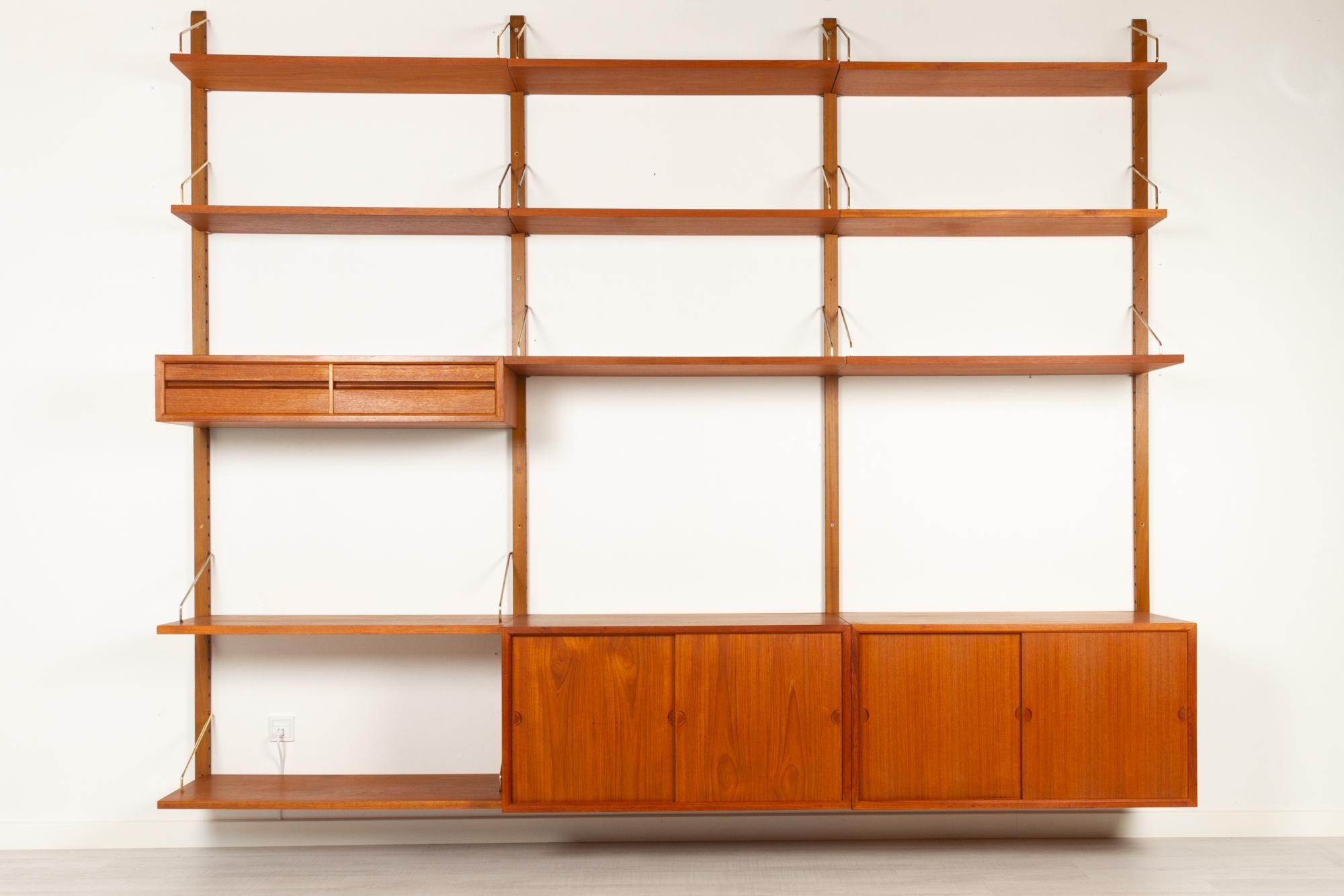 Vintage Danish teak wall unit by Poul Cadovius for Cado, 1960s.
Mid-Century Modern 3 bay shelving system model Royal. This is a original vintage shelving system designed in 1948 by Danish architect Poul Cadovius. 
Cadovius had the revolutionary