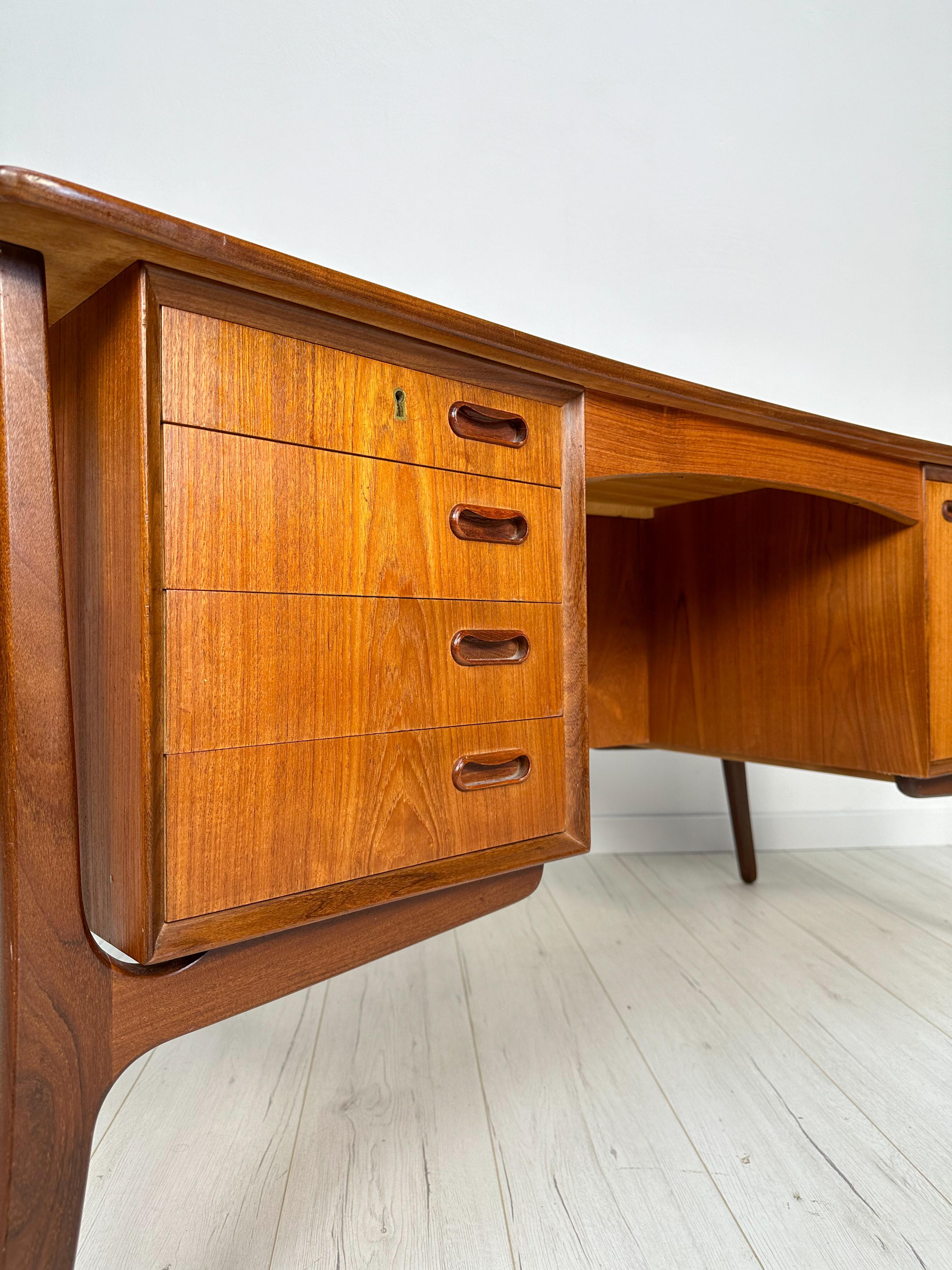 Beautiful vintage bow-fronted writing desk original from the 1960s featuring 5 drawers with backside shelving for additional storage space. High-quality teak wood. Designed by Svend Aage Madsen for H.P. Hansen, made in Denmark. Neat condition with