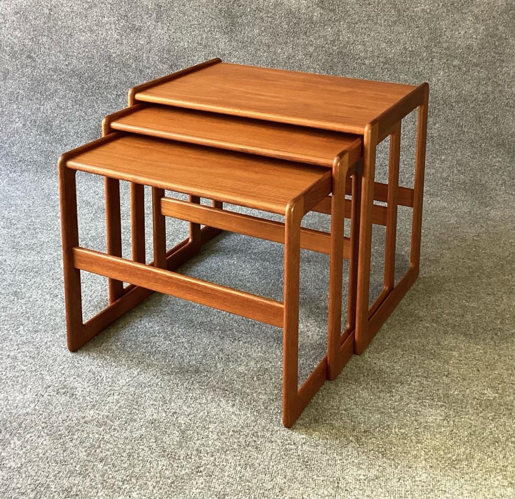 This lovely set of three nesting tables in teak are not only handsome, they are incredibly versatile. With curved corners, raised edges, and exquisite joinery, they offer several subtle, refined details. From an home circa late 1960s. 

No breaks