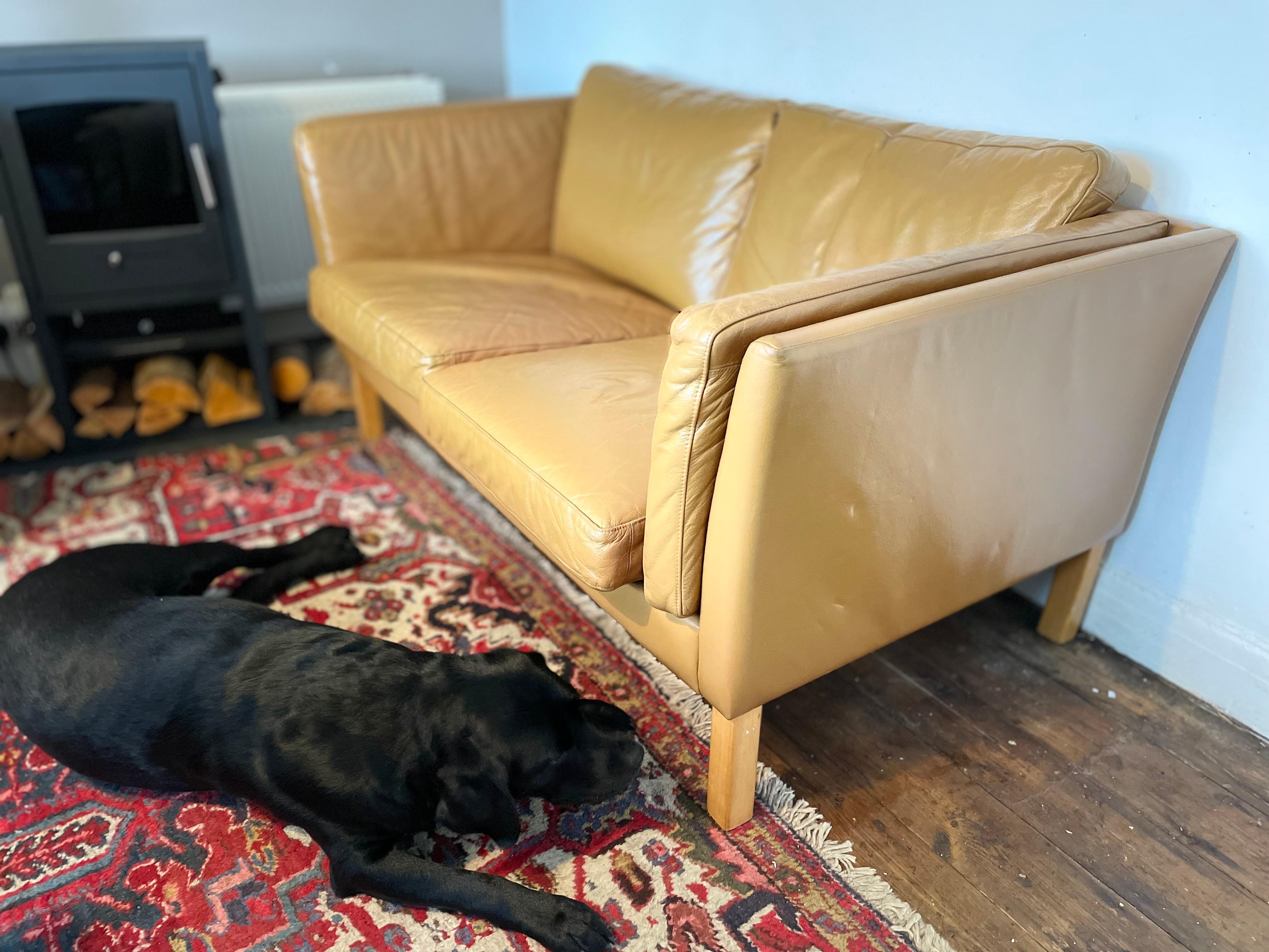 Danish Maker Stouby, 1970s.

This elegant 1970s Vintage Danish Two Seater Sofa Tan Leather is attributed to Stouby and showcases the timeless simplicity of Scandinavian design. Upholstered in beautifully aged tan leather, the piece has developed a