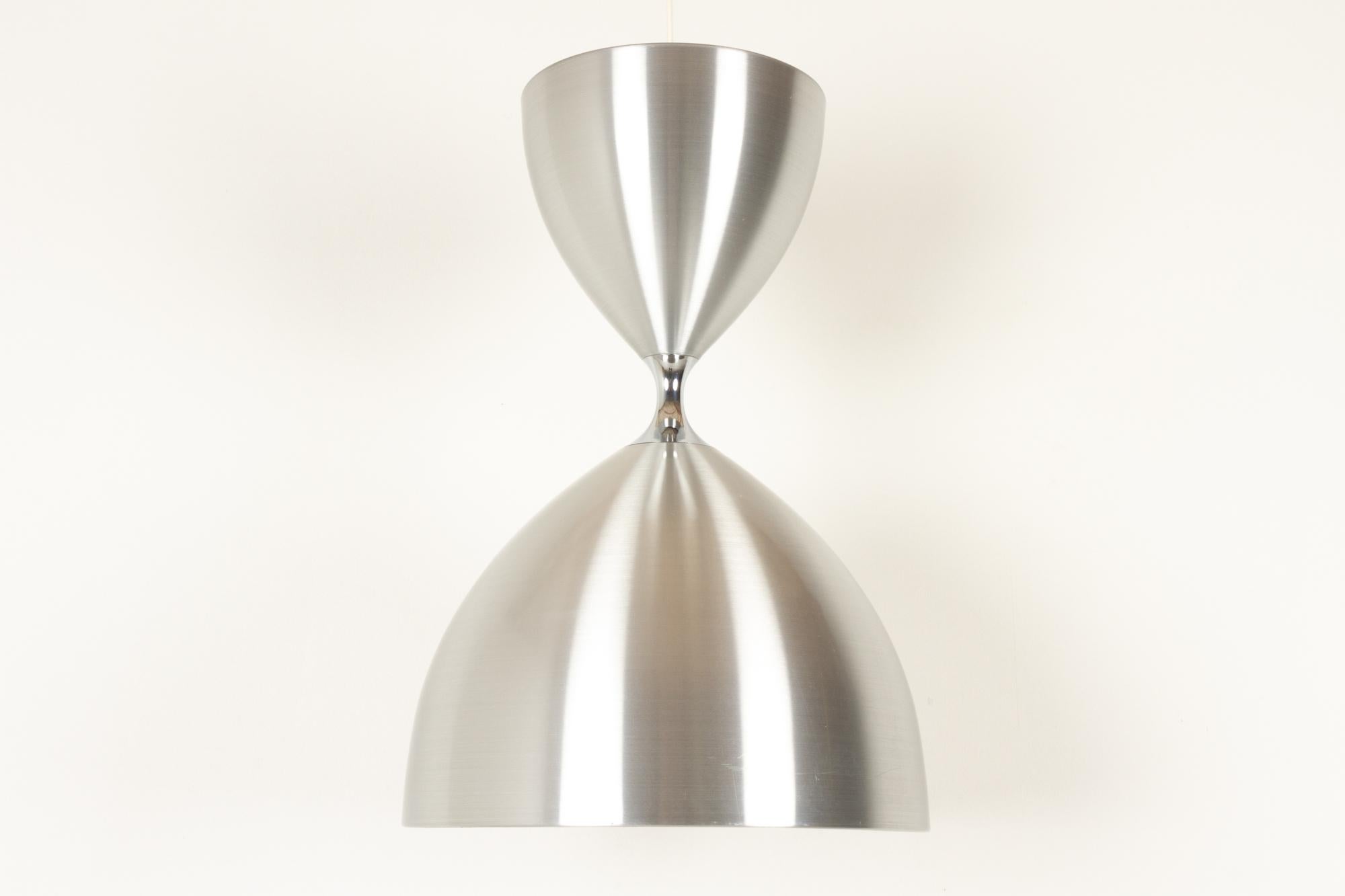 Vintage Danish Vega ceiling pendant by Jo Hammerborg for Fog & Mørup, 1960s.
Iconic Danish modern lighting design by Danish designer Jo Hammerborg. Large hourglass shaped ceiling lamp in brushed aluminium with dual function. Upward light in the top