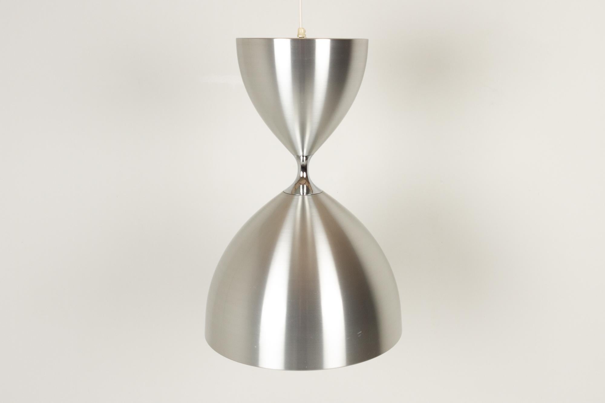 Vintage Danish Vega ceiling pendant by Jo Hammerborg for Fog & Mørup, 1960s.
Iconic Danish modern lighting design by Danish designer Jo Hammerborg. Large hourglass shaped ceiling lamp in brushed aluminium with dual function. Upward light in the top