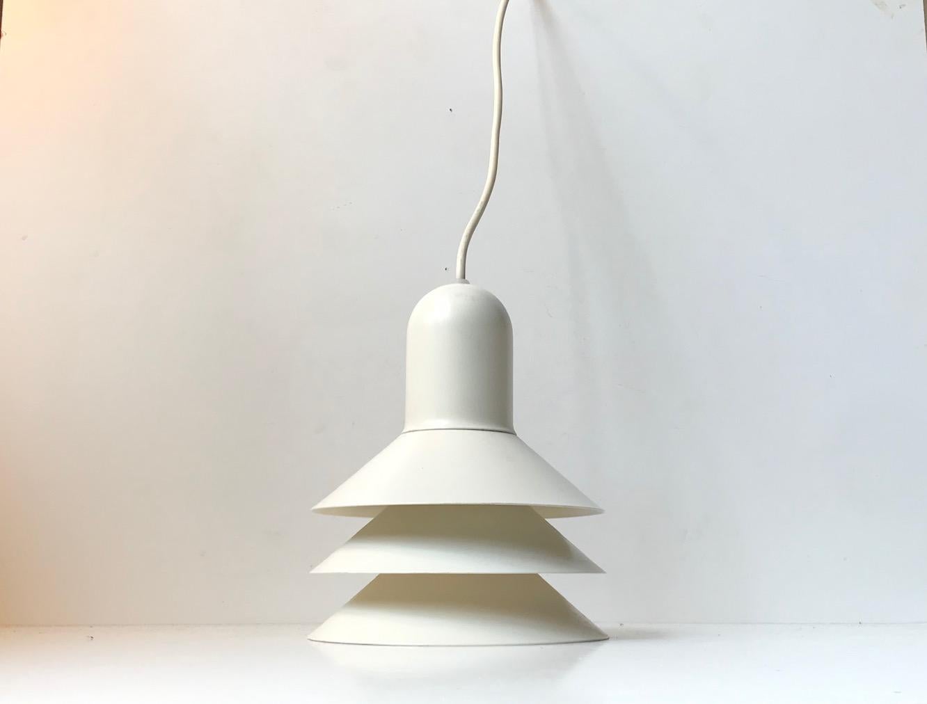 This white tiered pendant lamp comes in steel and was manufactured by Lyfa in Denmark during the 1980s.