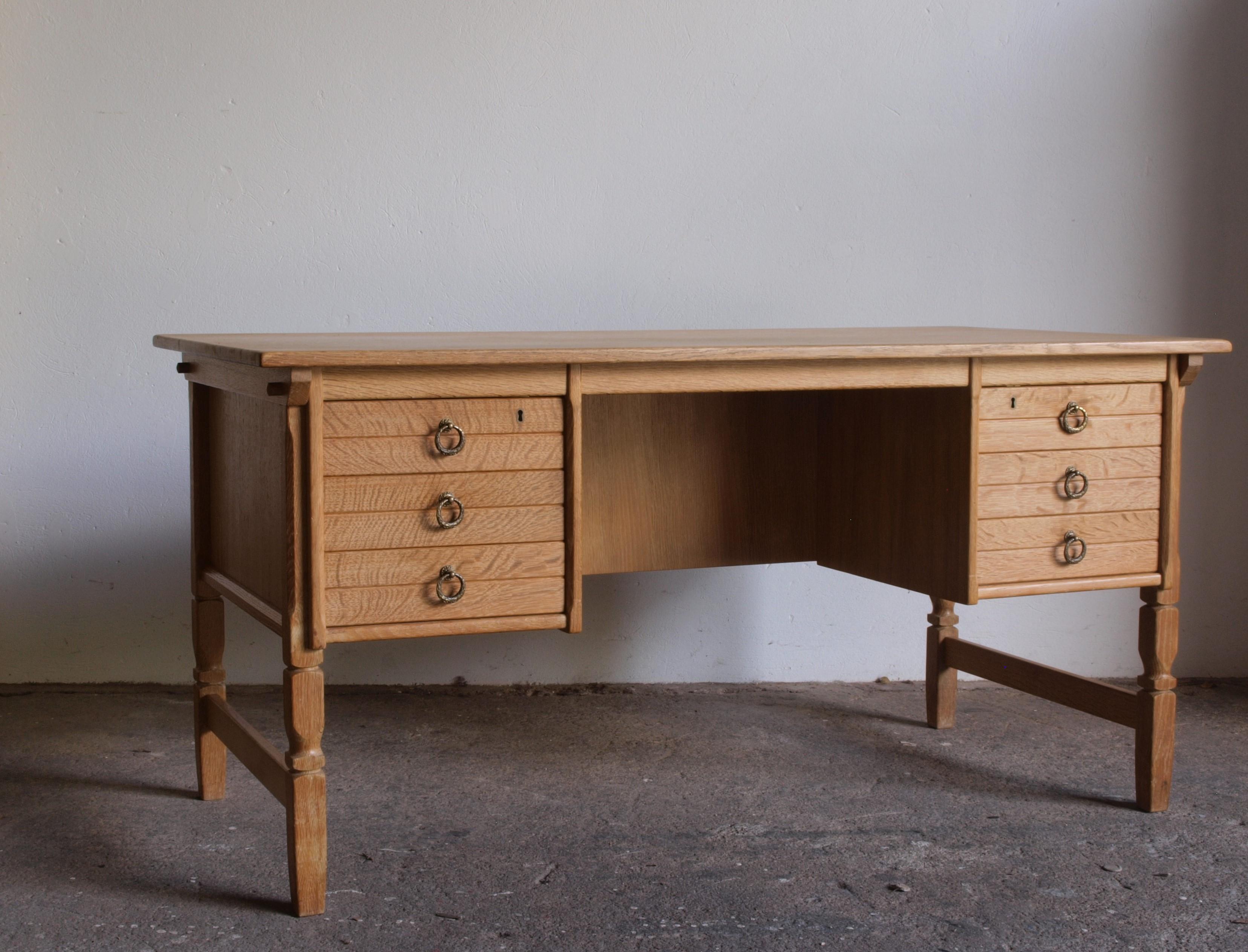 Solid oak writing desk complete with drawers, by and documented to the Danish furniture designer Henning Henry Kjærnulf, a compelling piece. This creation harmoniously blends bold Baroque elements with the finesse of Mid-Century Modernism, resulting