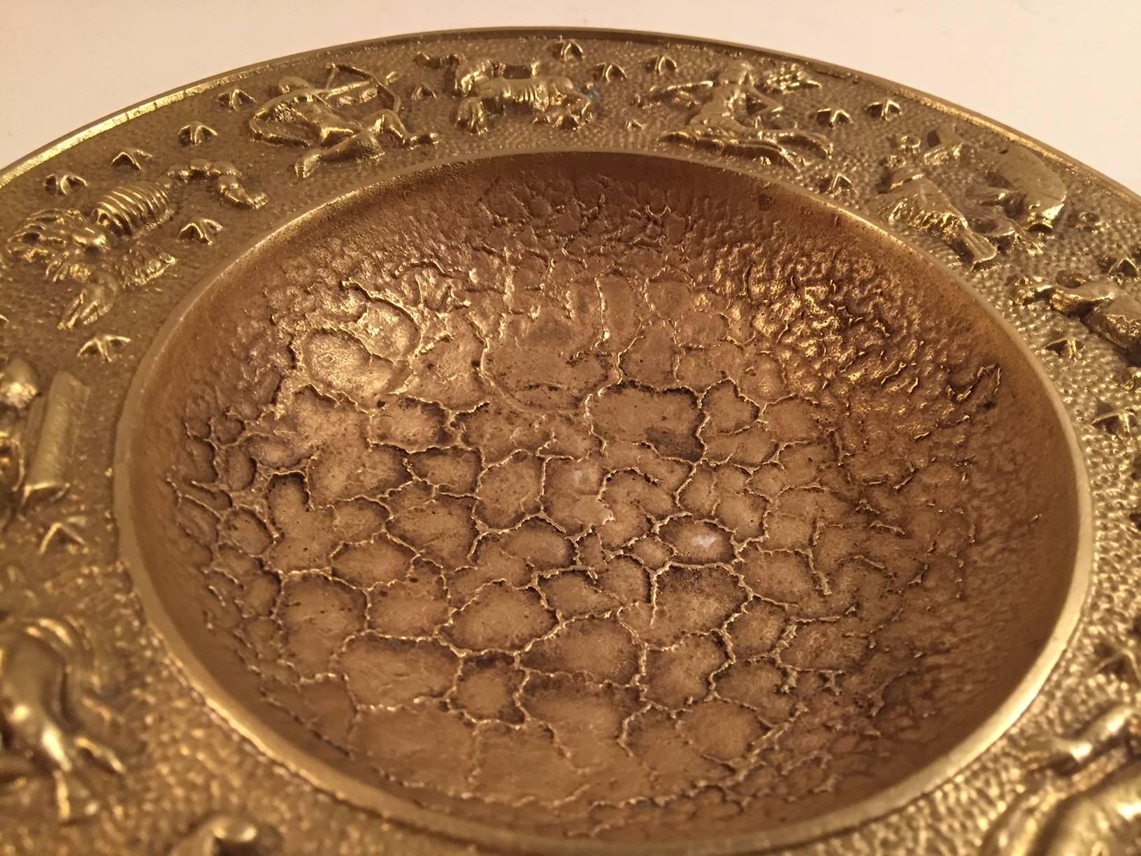 Decorative and heavy bronze bowl with zodiac motifs /signs and a surface that mimics the surface of the moon. It was manufactured and designed by NM/Nordisk Malm in Denmark during the late 1940s. Stylistically it borderlines between Art Deco and