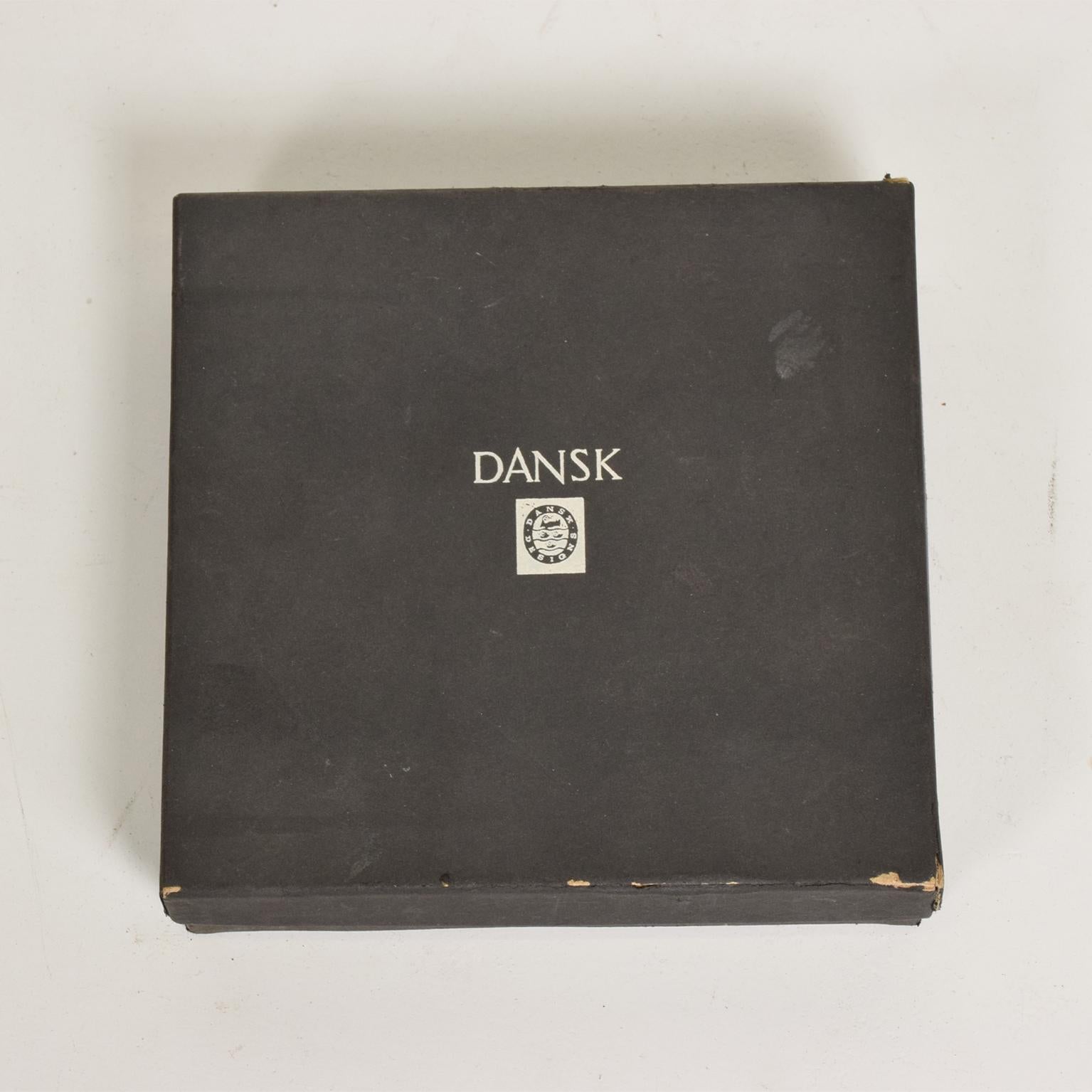 For your consideration, a vintage set of Dansk matches boxes in original packaging.

Each wooden box is made of teak with a stainless steel inlay decoration. They measure: 1 3/4