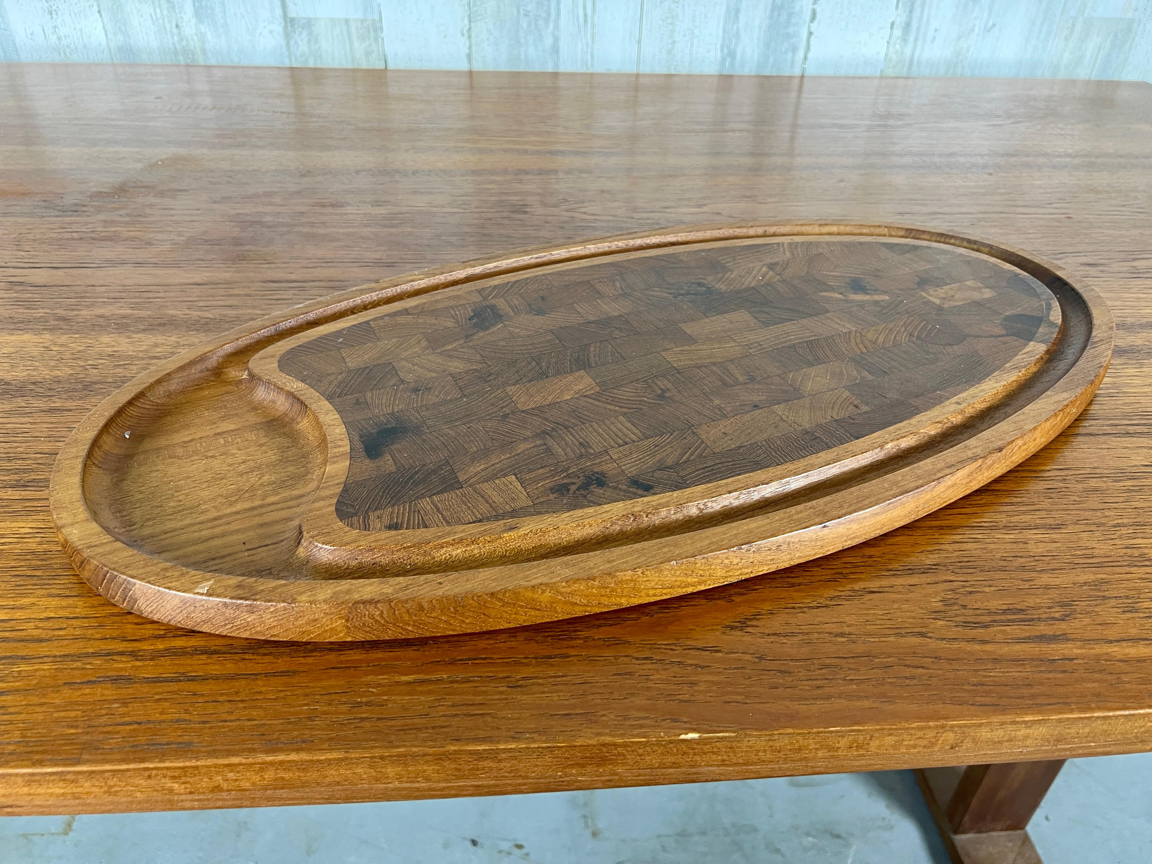 Oval solid teak cheese board with end grain center.
Designed by Jens Quistgaard.