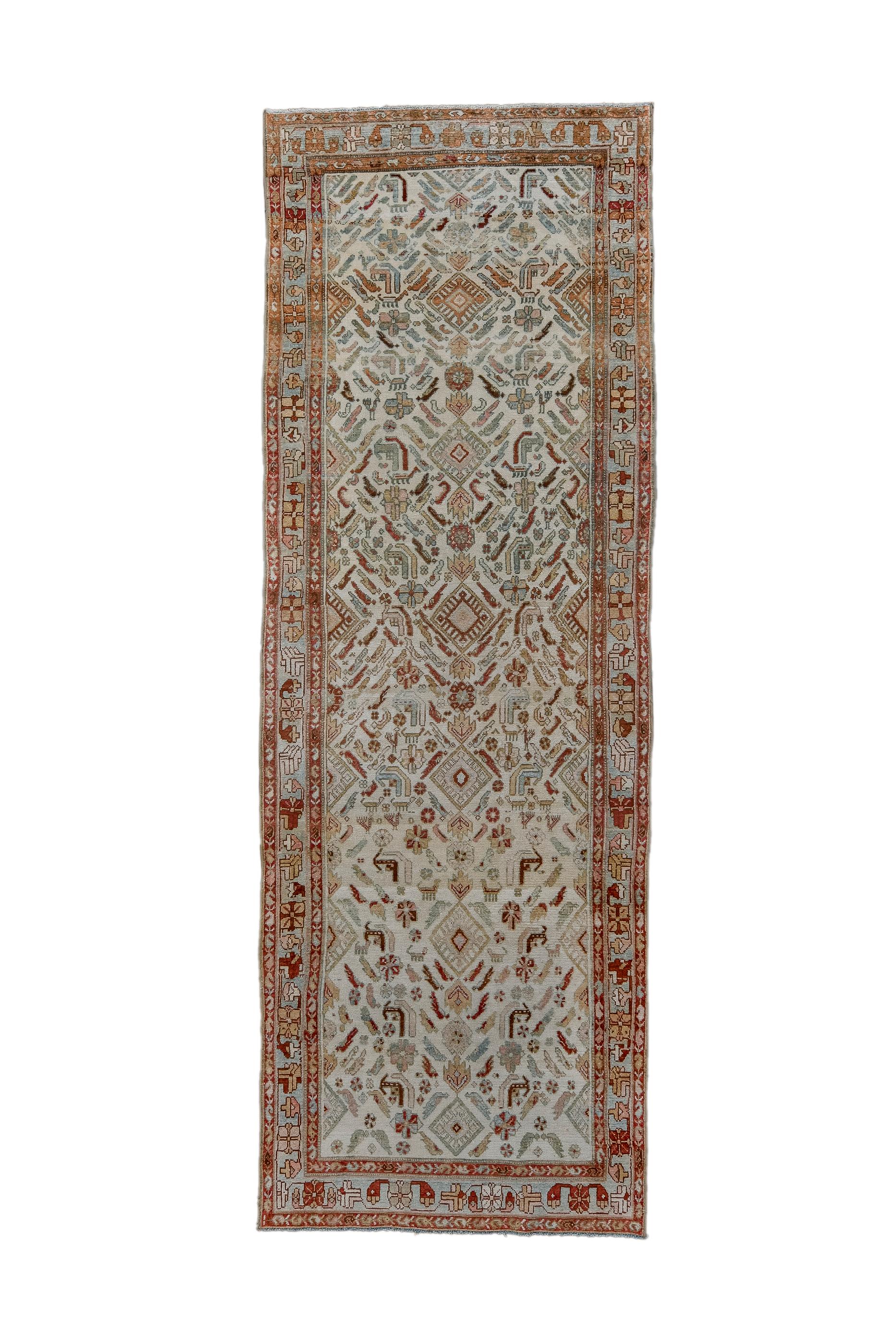 This Hamadan district kellegi (long rug) shows a broken allover Herati design centred on a column of internally rayed diamonds, on an ecru ground.  Pale blue strip style border of modules of rosettes and drooping florets. Dergazines are usually red,