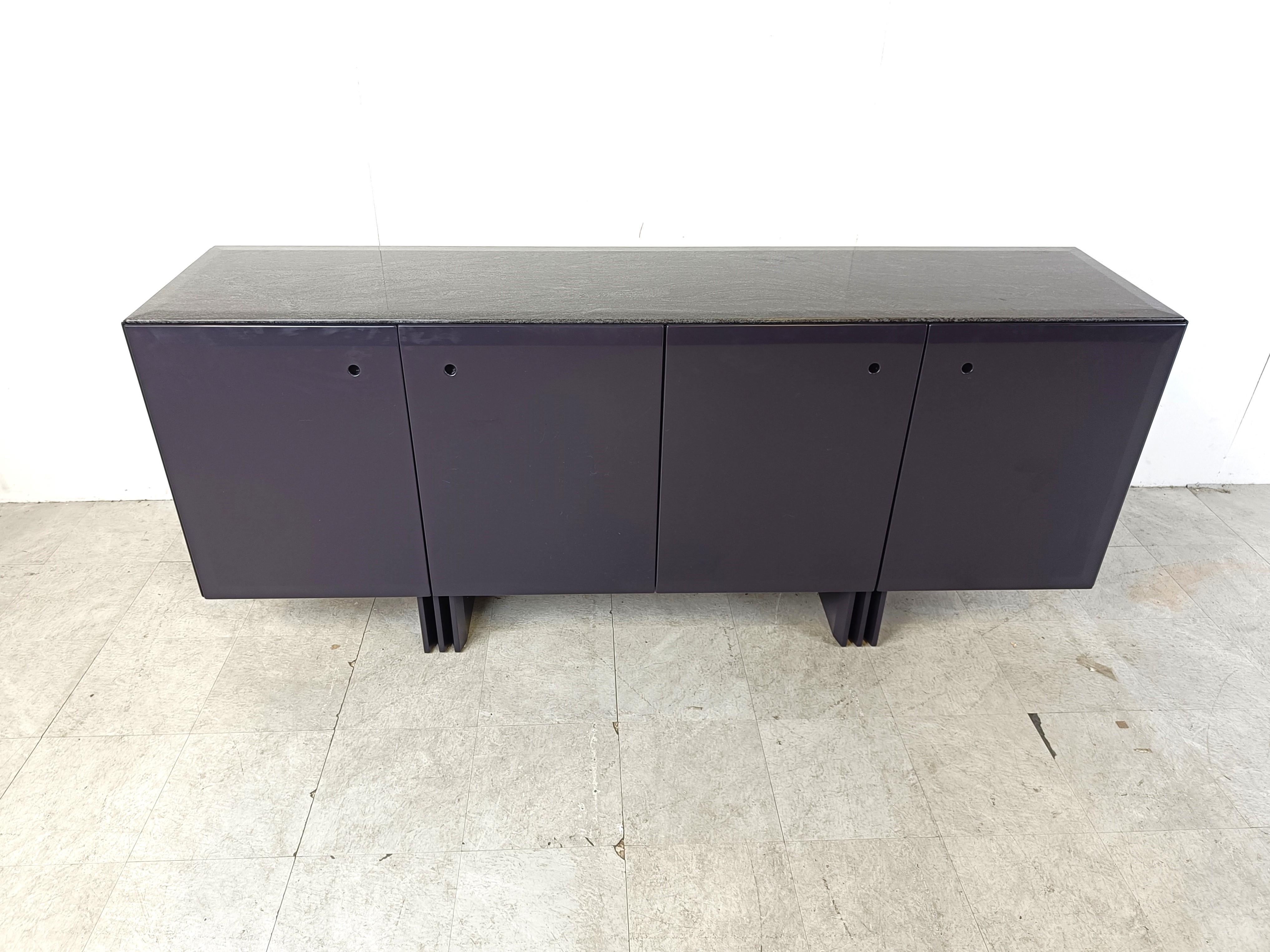 Vintage dark blue wooden sideboard with a grey marble top and glass shelving.

Beautiful timeless piece which offers plenty of storage space.

Very well made

1980s - Belgium

Dimensions:
Lenght: 200cm/78.74