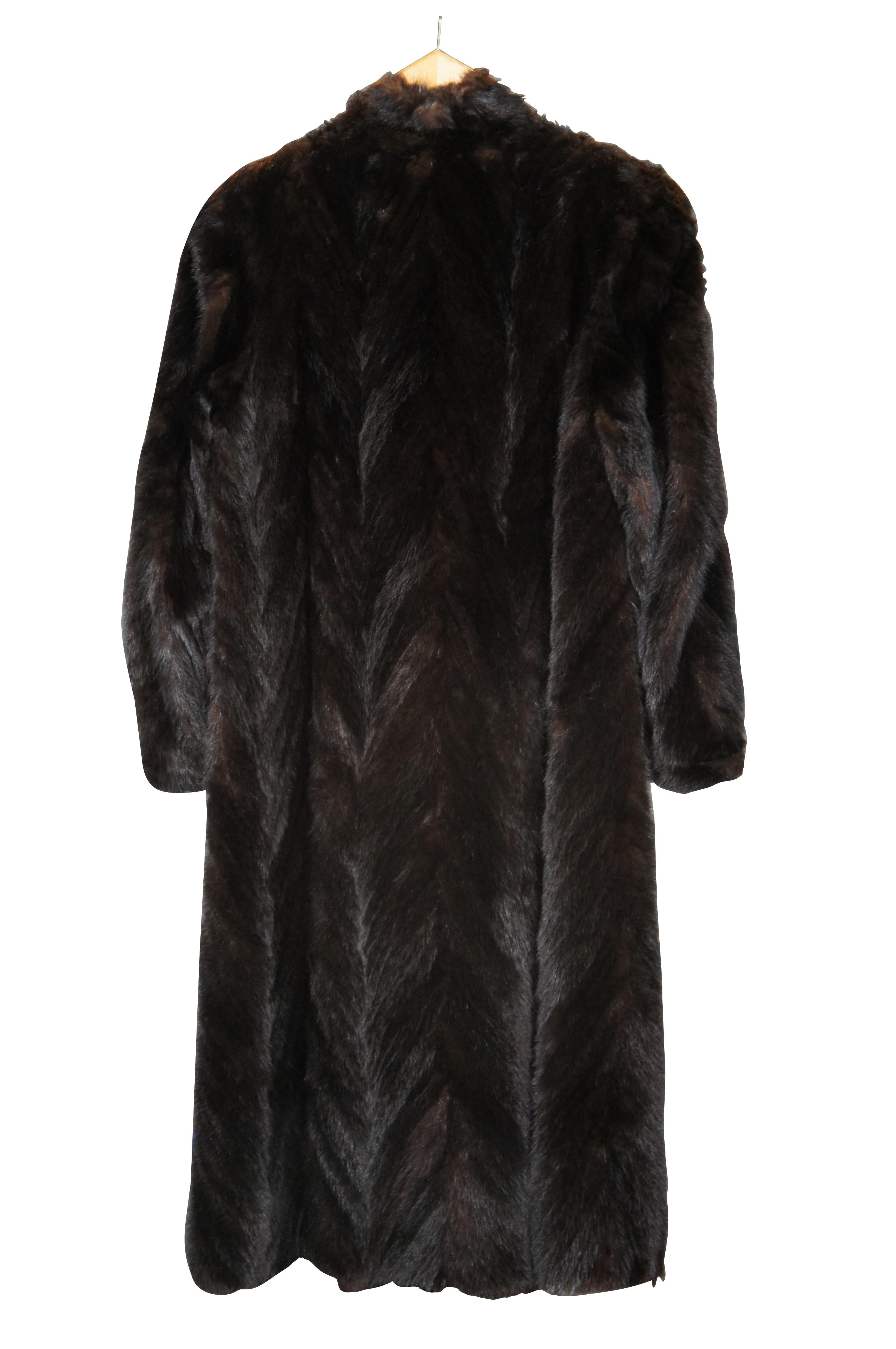 Vintage mid to late 20th century women’s, full length, dark brown mink fur coat featuring a subtle chevron pattern, hook and loop closure all the way down the front, two side pockets and brown lining. Includes Ambienence by Spiegel garment storage