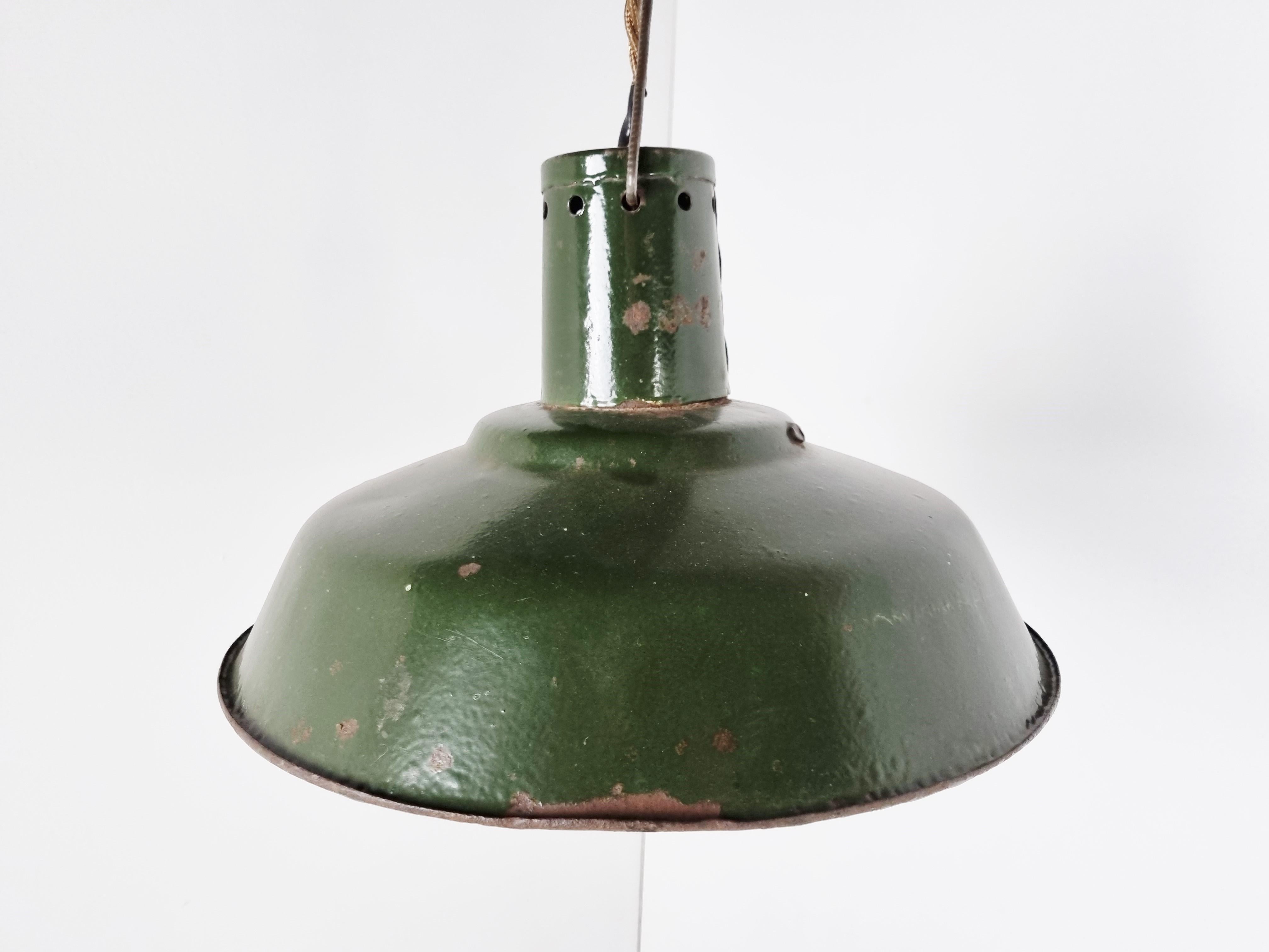 Vintage industrial pendant lights in dark green enamel. 

The lamps emit a soft light thanks to the white enamelled finish on the inside.

The lamps where salvaged in Latvia (former USSR) and have a beautiful patina

Fully rewired with a nice