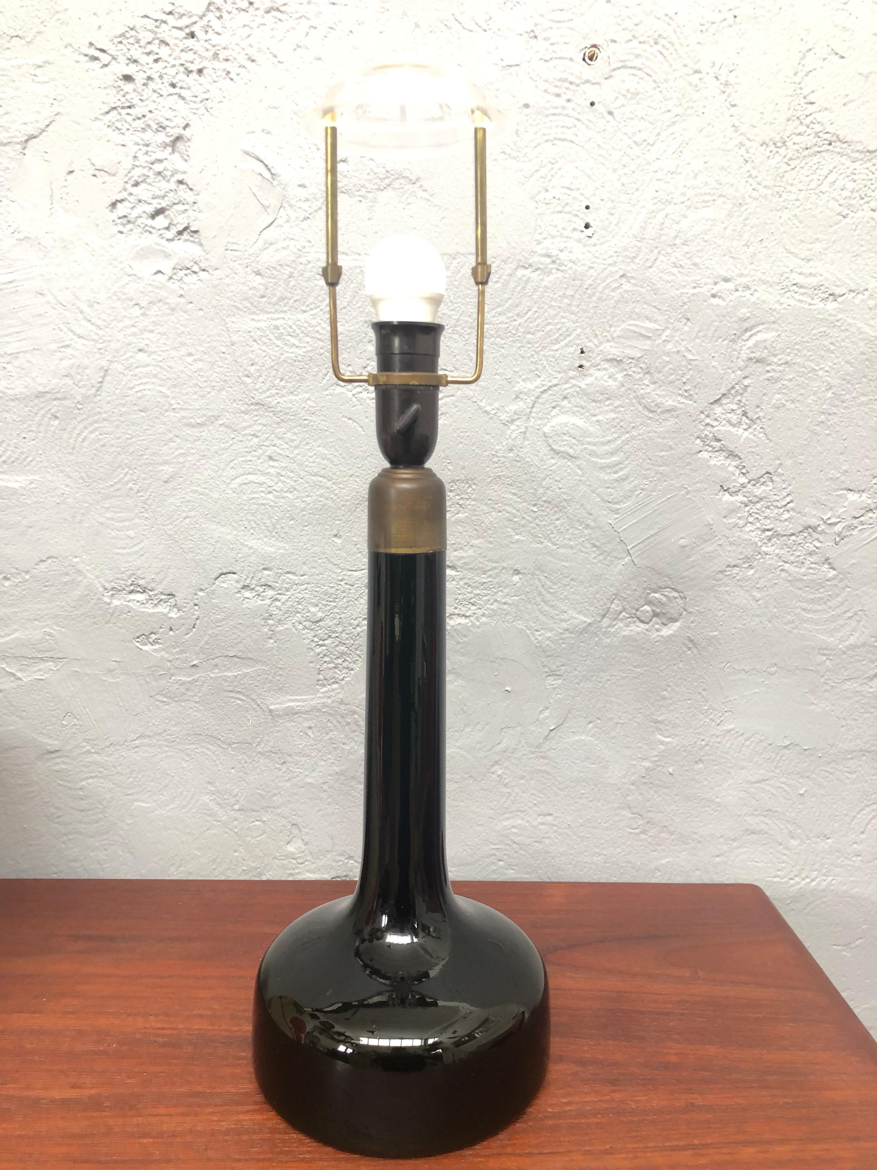 A vintage hand blown glass table lamp designed by Biilman-Petersen for Le Klint of Denmark in 1948. 
The dark green glass is in great vintage condition with age related wear. 
It has been rewired with twisted gold cloth flex and insulated where it