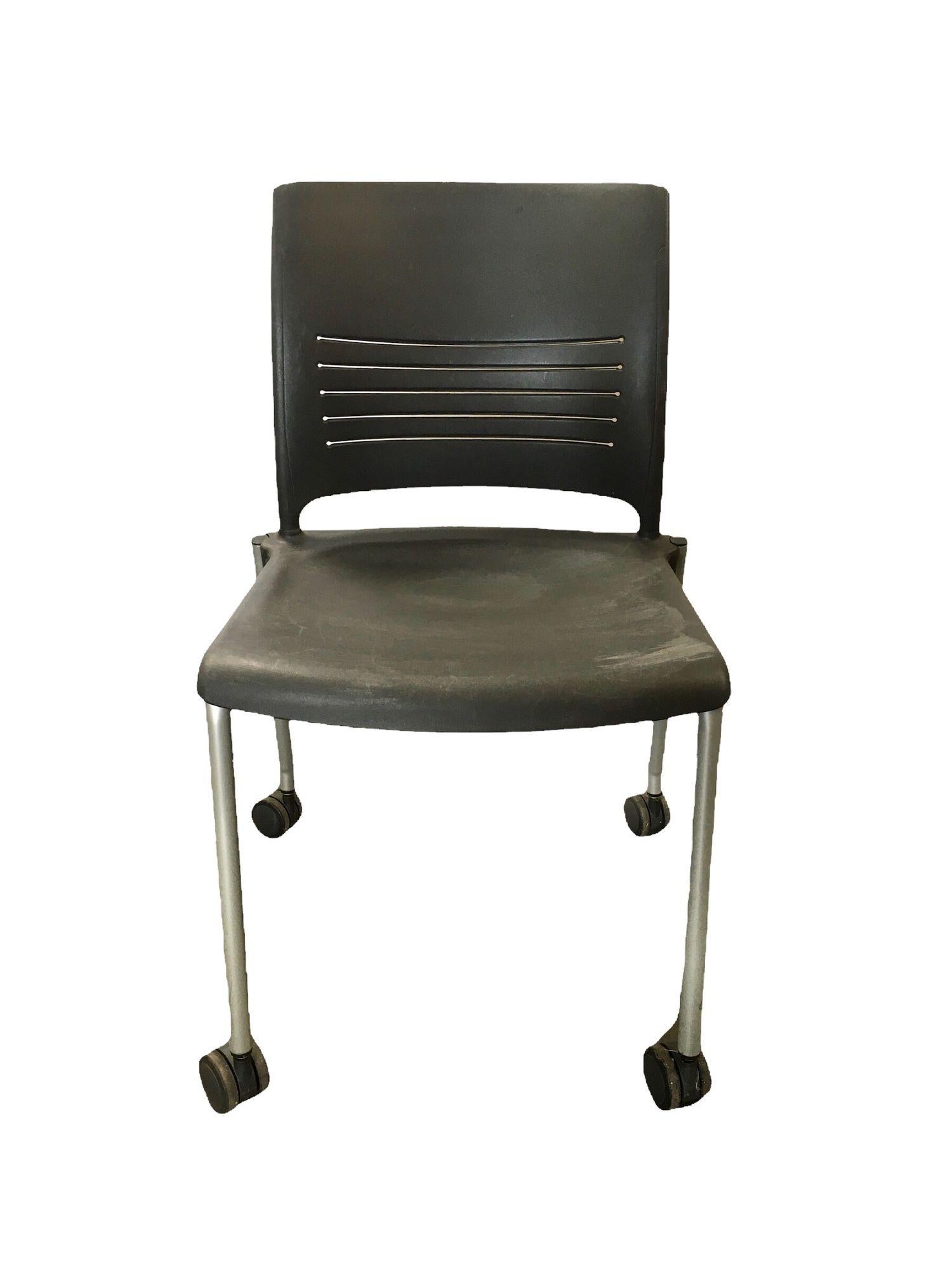 Vintage Dark Grey Plastic Rolling Desk Chairs by Giancarlo Piretti for Strive. These plastic chairs are easy to move around with the wheels on the bottom and can serve as desk chairs, waiting rooms, or even as additional seats for guests. They are
