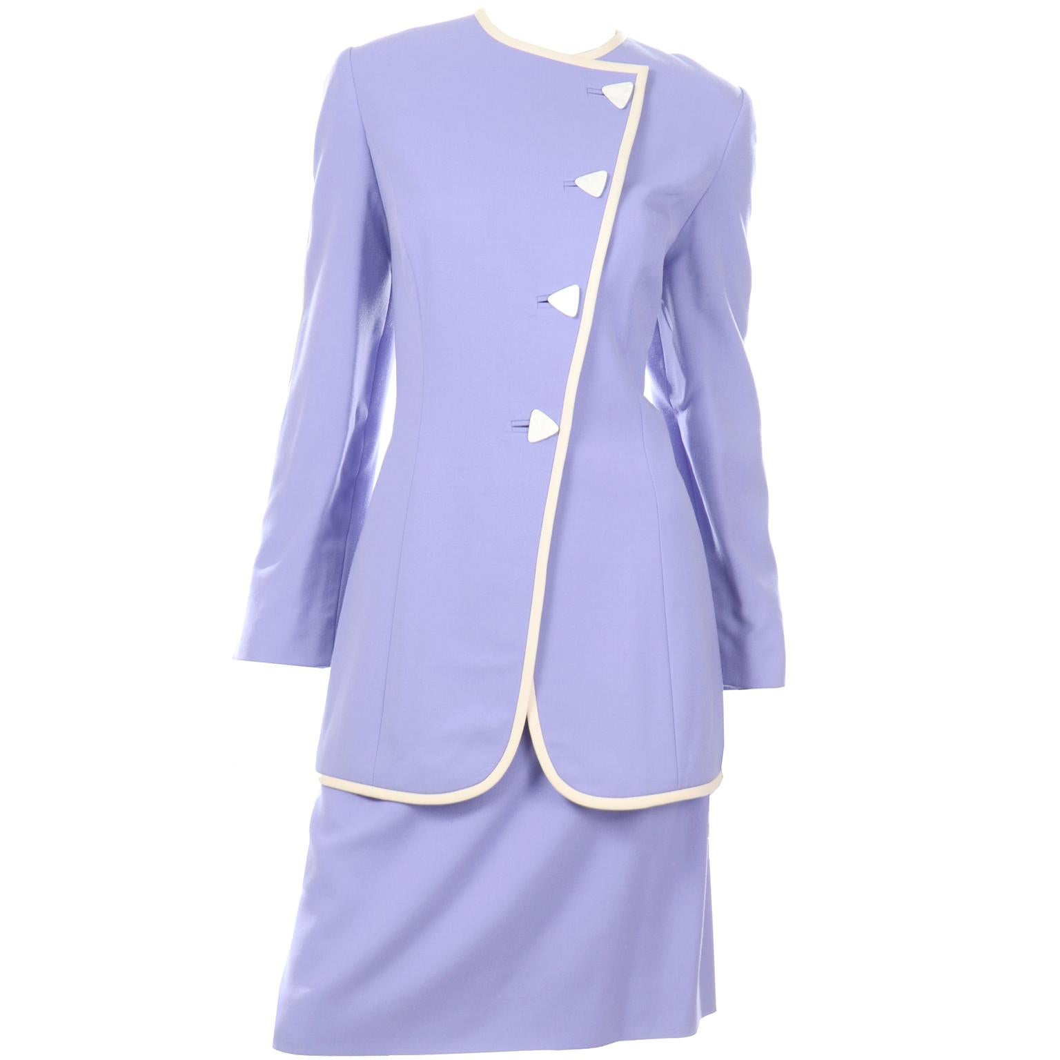 This is such a pretty David Hayes vintage 2 piece suit with a  longline blazer style jacket and a straight skirt. The jacket is fully lined, has a round neck, and closes with unique shell triangle buttons. The periwinkle bluish purple color of the