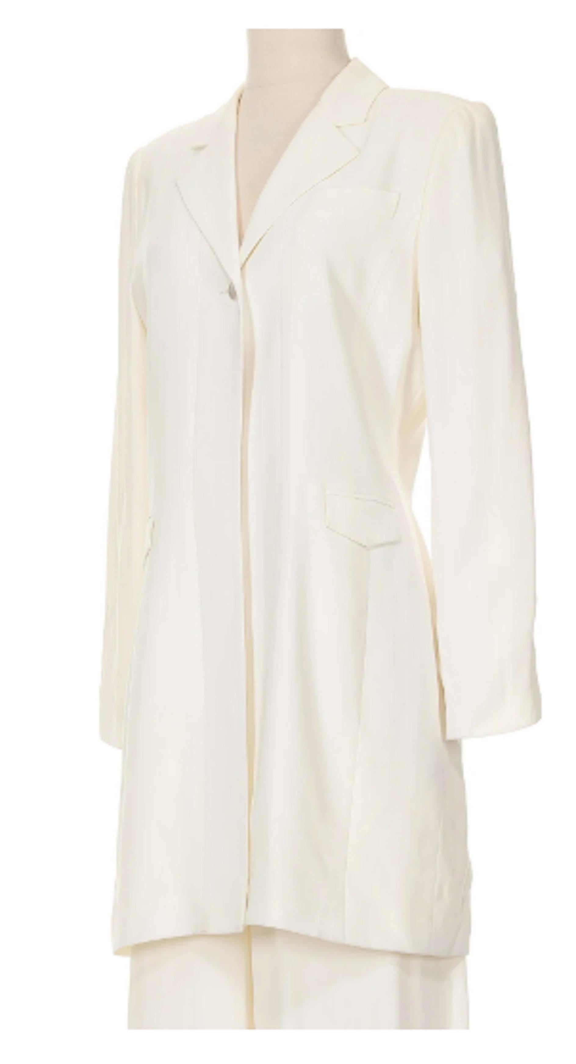 David Rodriguez White Blazer Jacket and Flare Pants. Circa 2005-2005. Crisp white single button jacket and flare pants with size zip closure. A classic ensemble from a Latin American designer who wowed customers with his sophisticated designers.
-